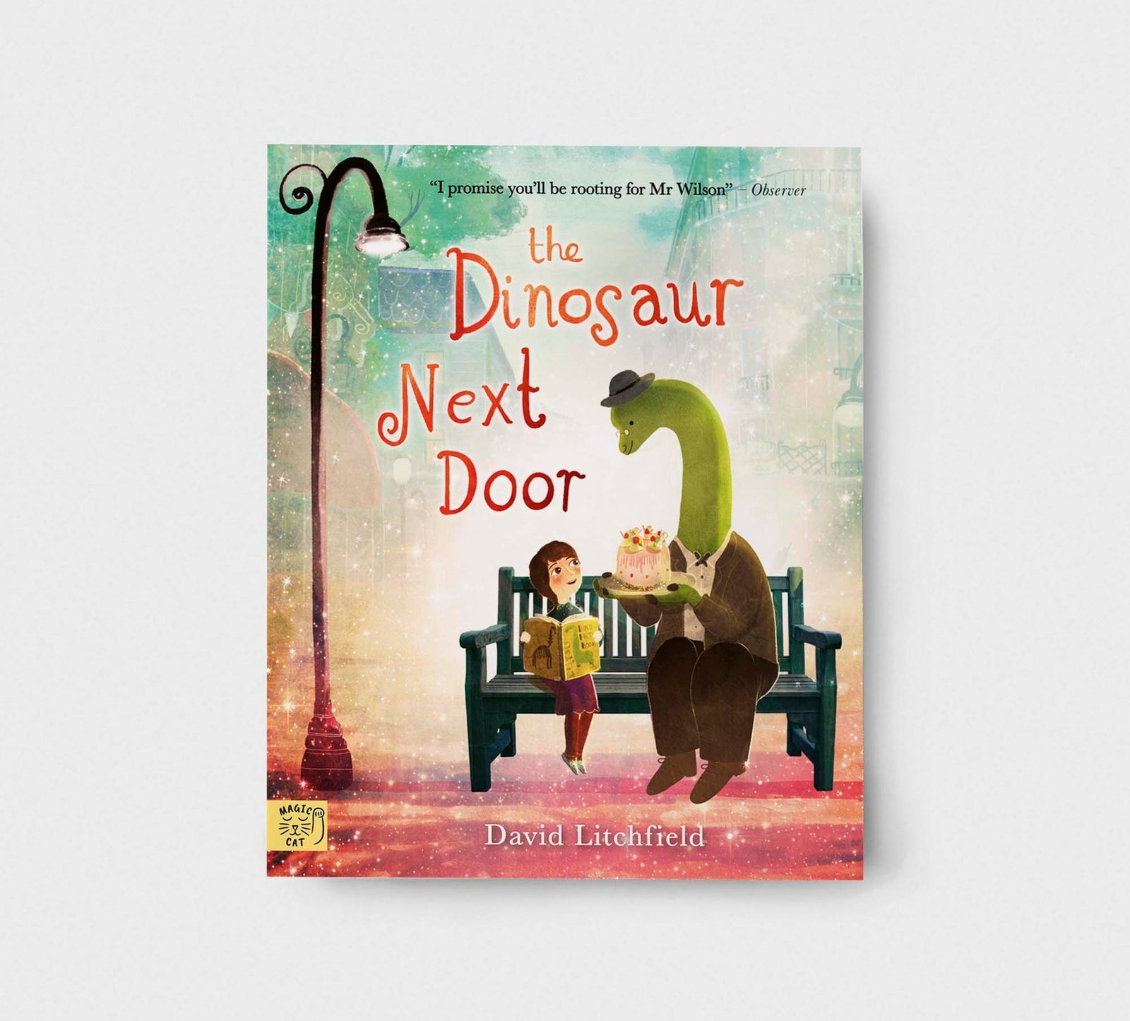 Book cover of 'The Dinosaur Next Door' with a dinosaur and child on a bench.
