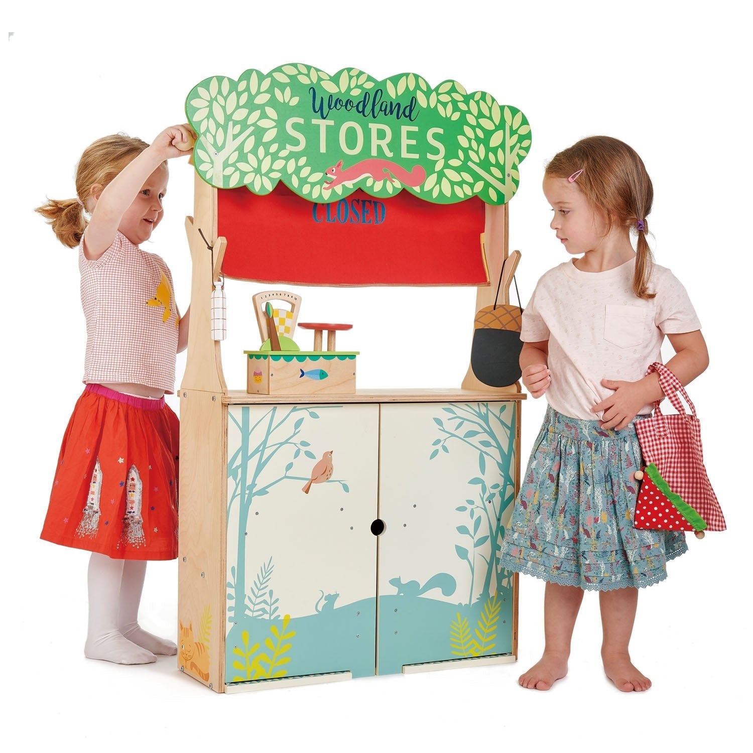 Children playing with a toy store set on a white background