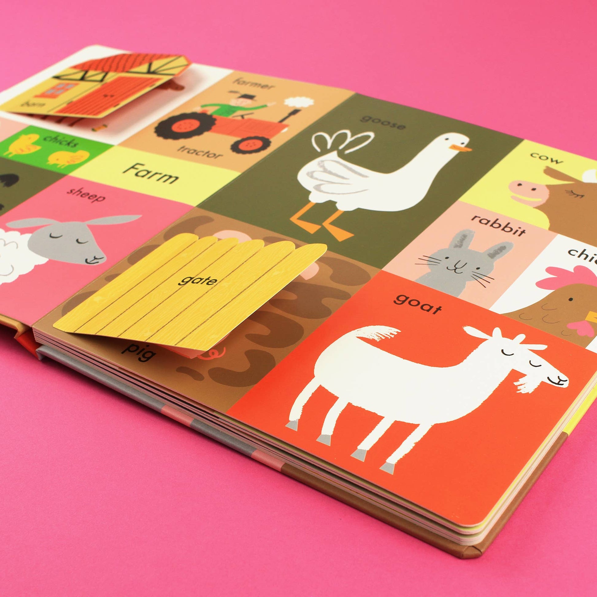 Children's book with farm animal illustrations on a pink background