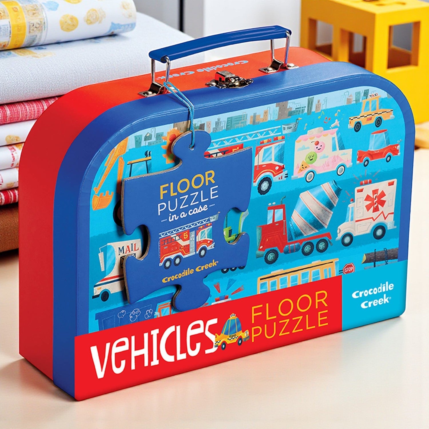 Children's vehicles floor puzzle in a colorful carrying case on a light background
