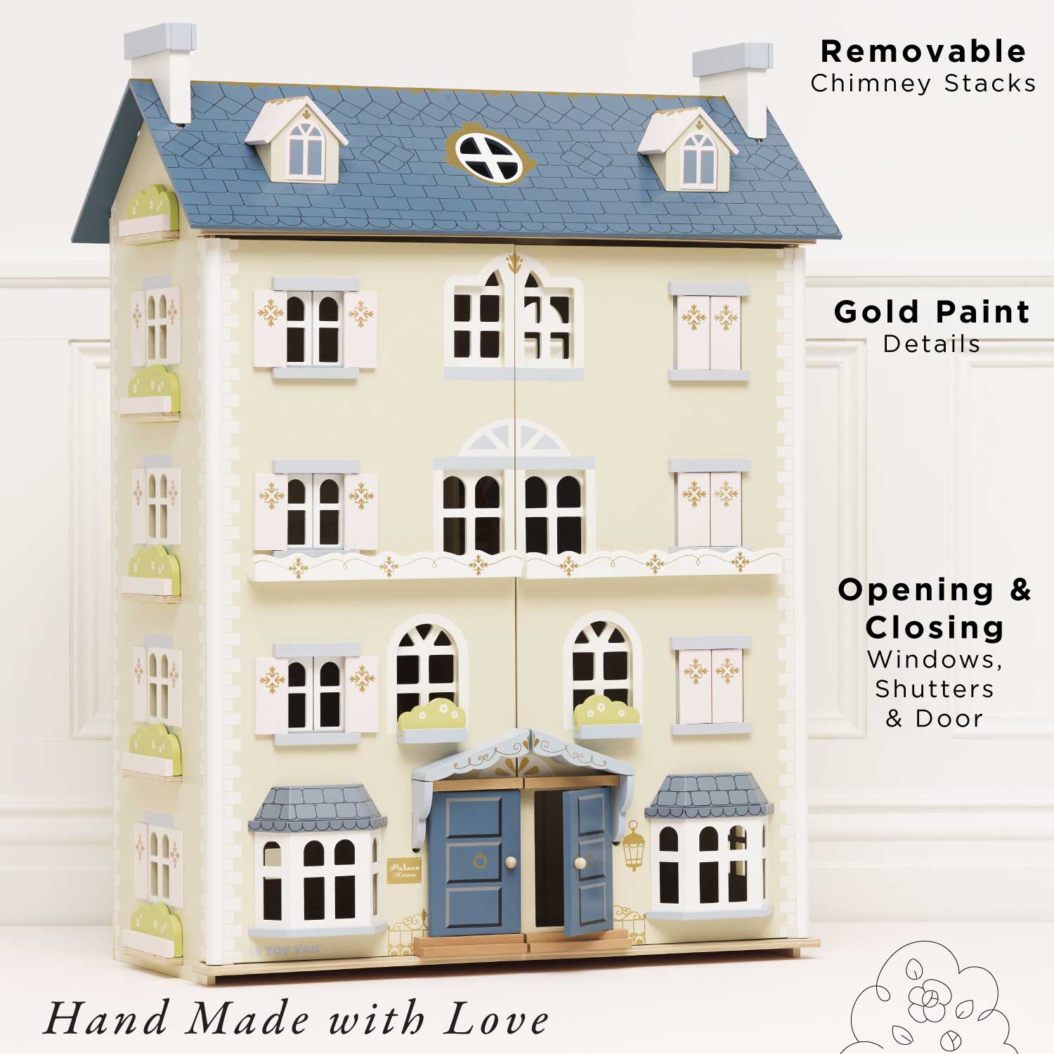 Toy house with gold paint details, removable chimney stacks, and opening windows on a white background.