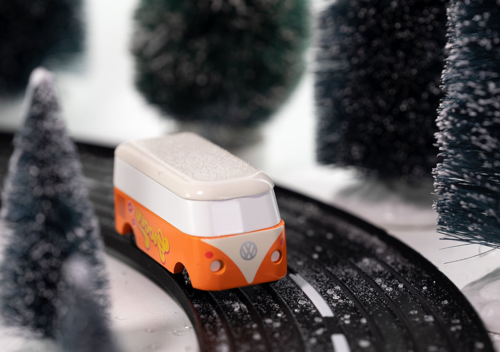 Model van on a track with snow-covered trees in the background