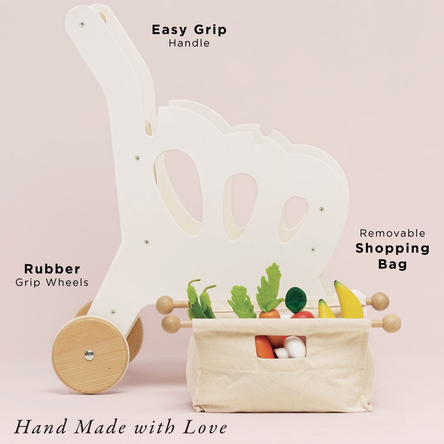Child's toy with wheels and a removable shopping bag on a pink background