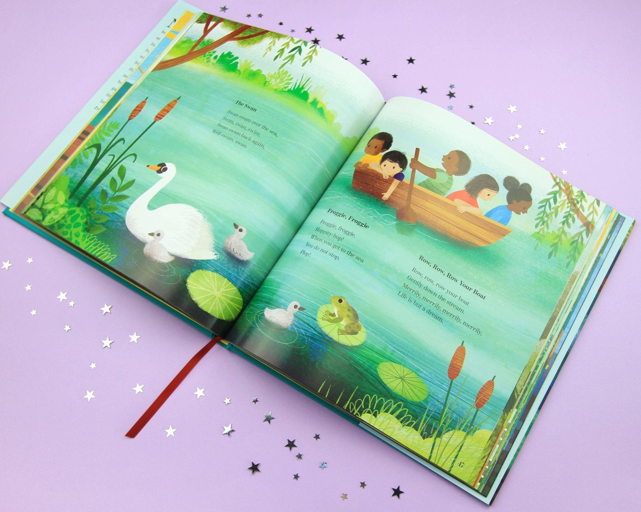 Open children's book with illustrations of swans, children in a boat, and nature on a purple background.