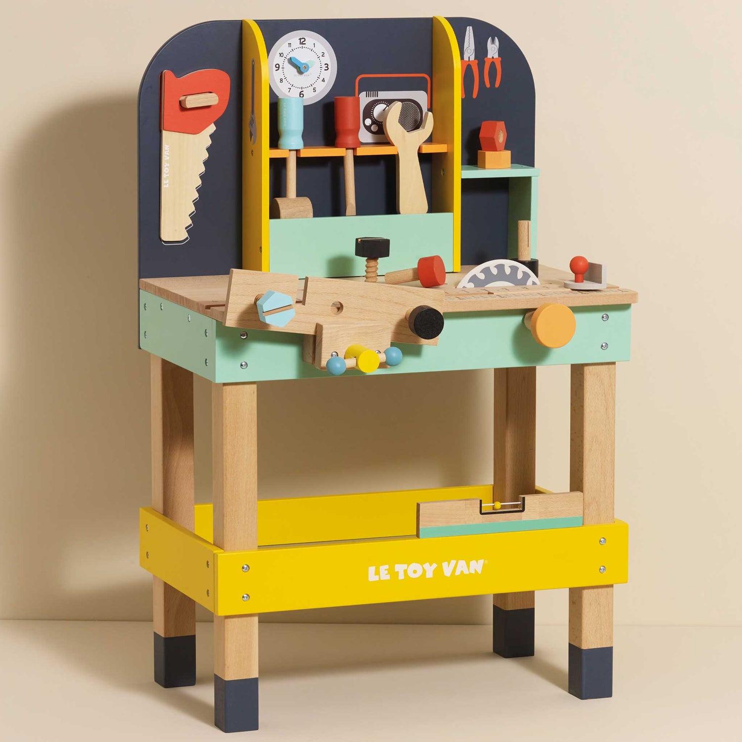 Colorful toy workbench with tools on a beige background, featuring the Le Toy Van brand.