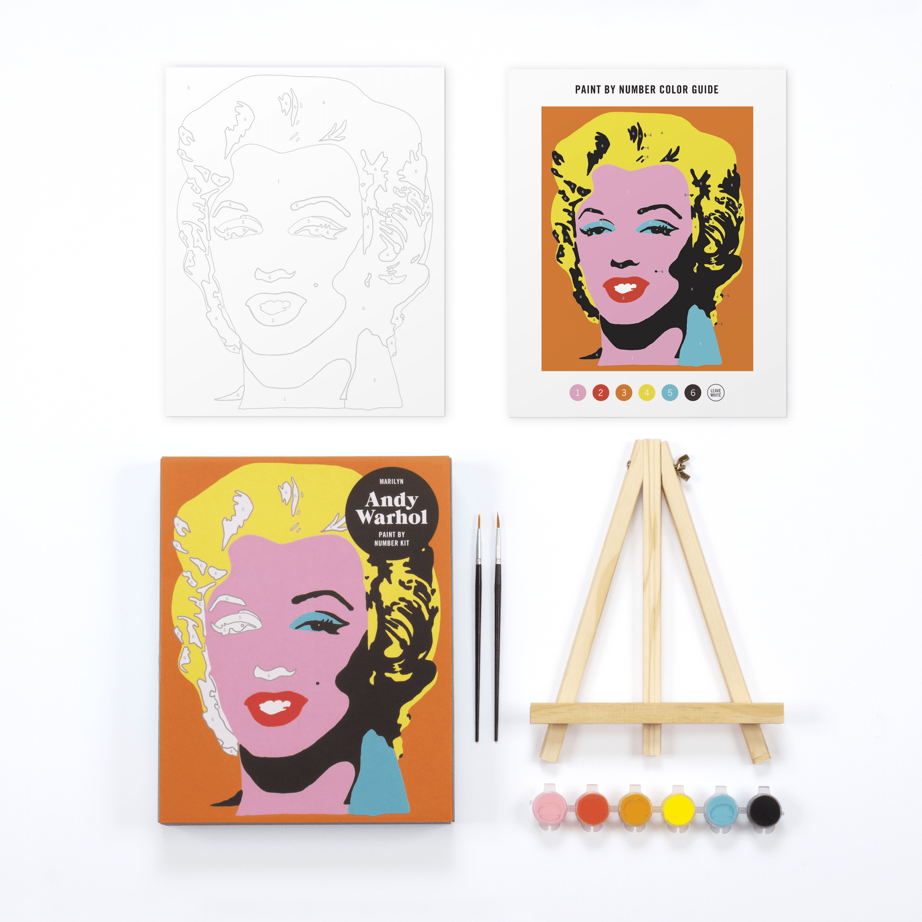 Paint by number kit with Andy Warhol-style portrait, color guide, and paintbrushes on a white background.