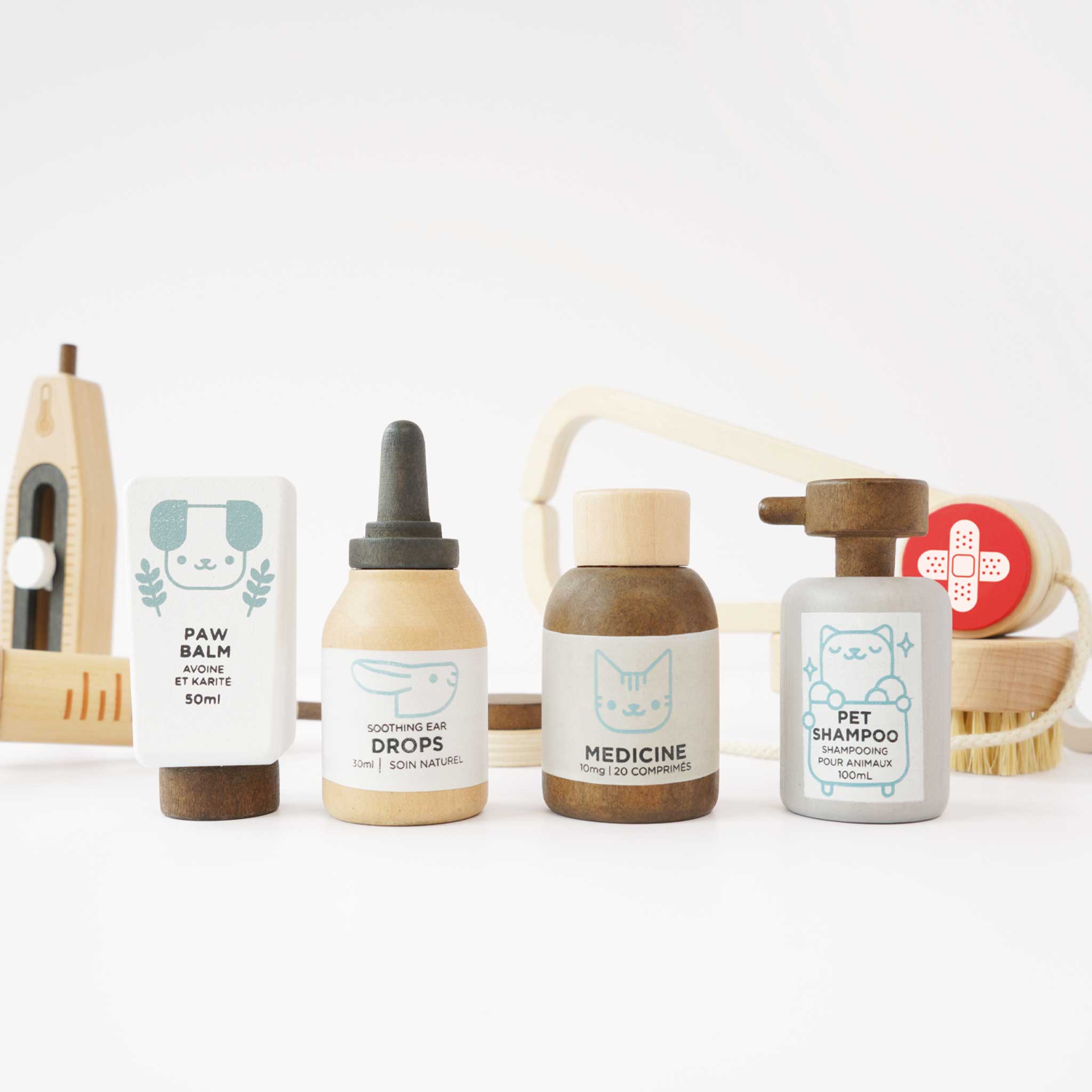 Set of pet care products including paw balm, drops, medicine, and shampoo on a white background.