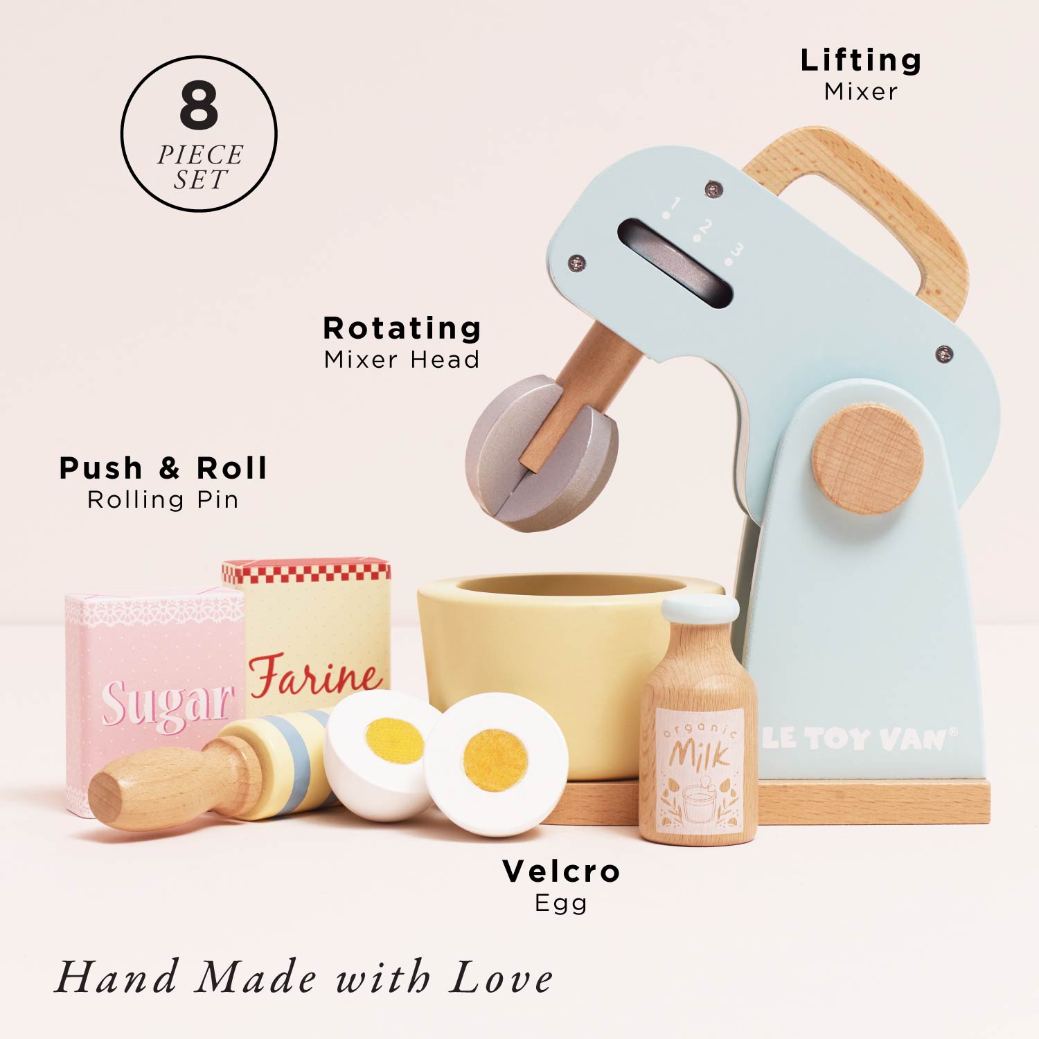 Set of toy kitchen utensils including a mixer, rolling pin, and eggs on a light background.