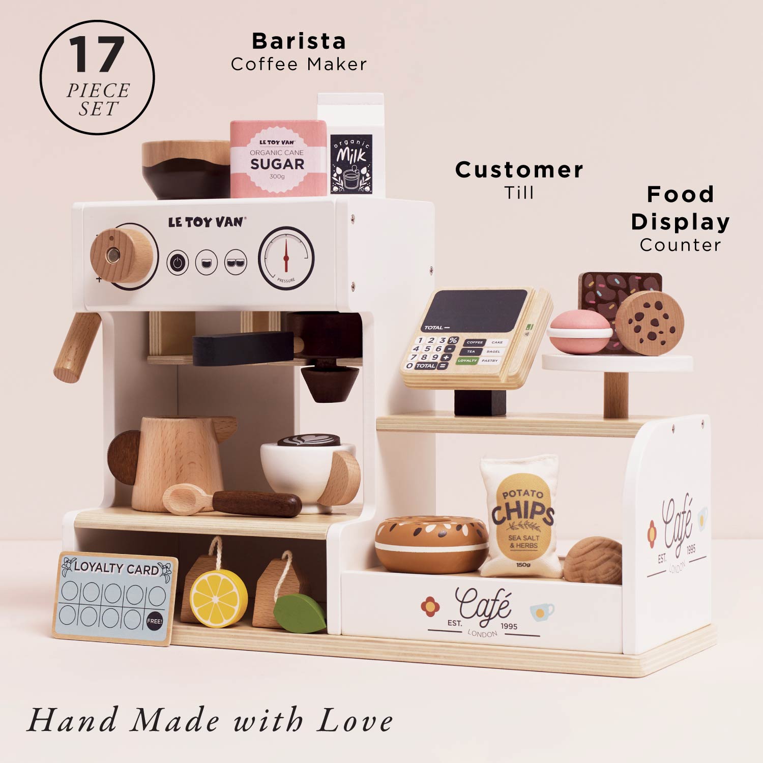 Toy coffee set with barista machine, till, and food display on a light pink background