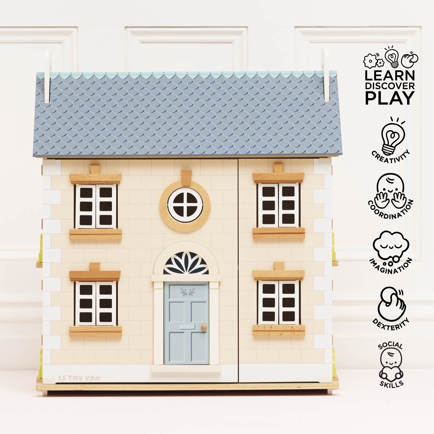 Toy house with a gray roof and blue door on a white background, featuring educational icons.