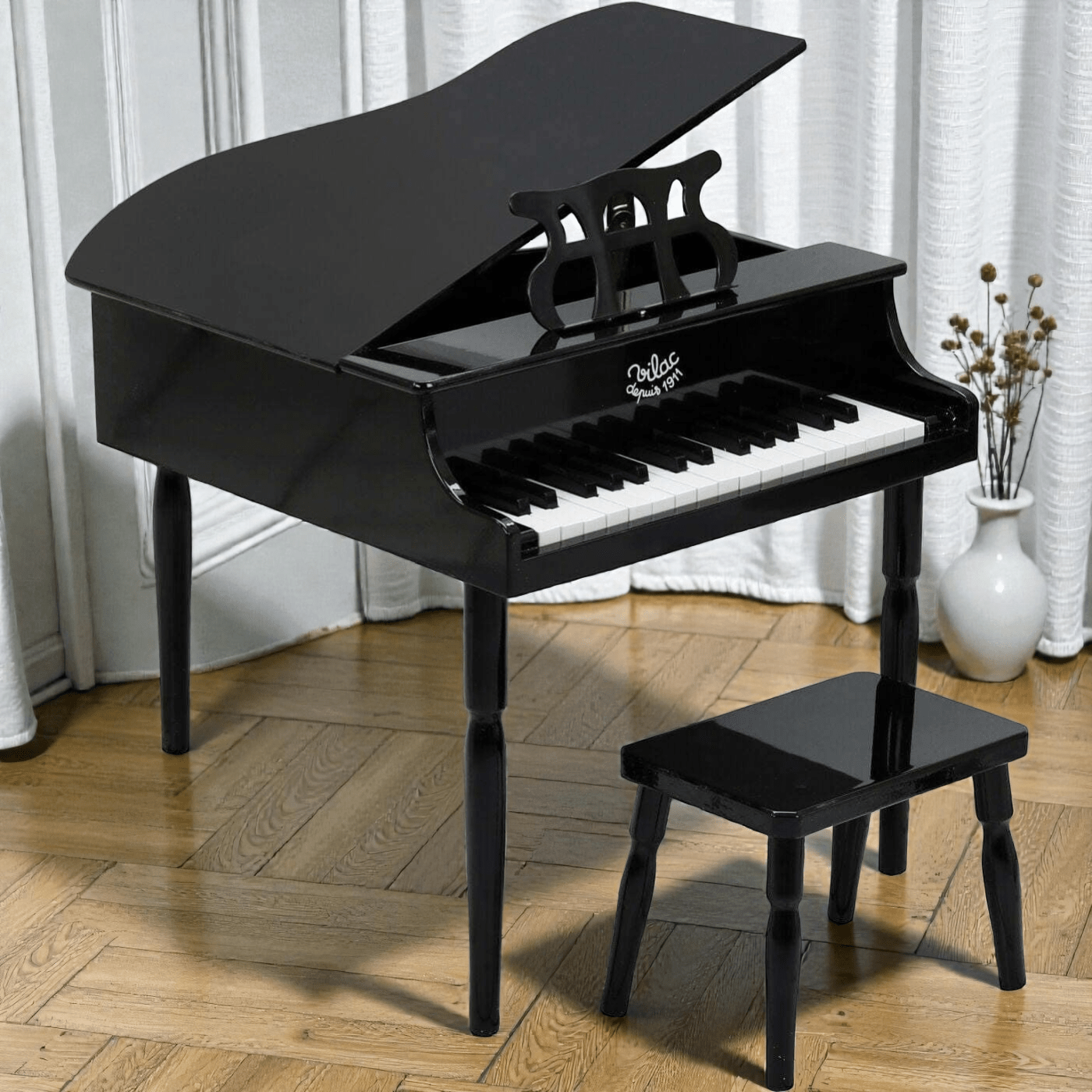 A stylish black grand piano in a living room setting with wooden floors 
