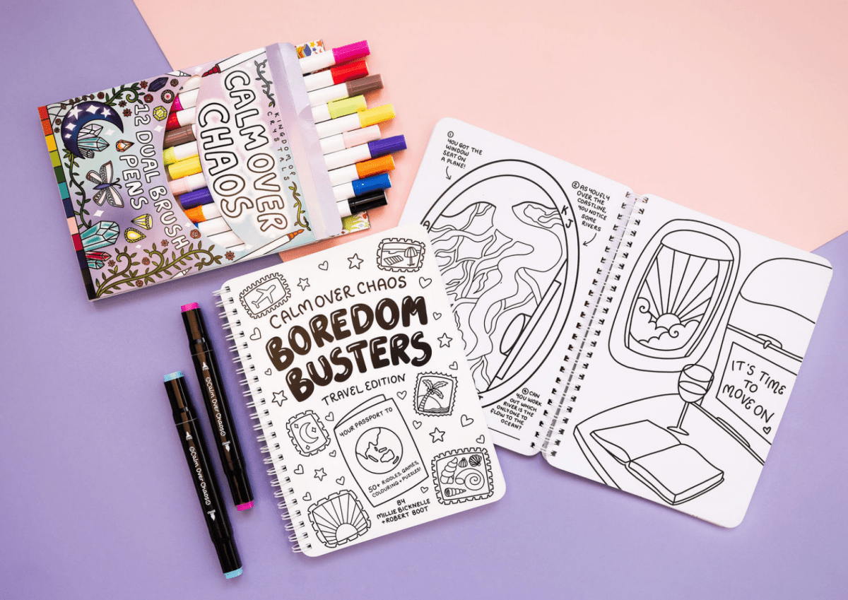 Coloring books and markers on a purple surface