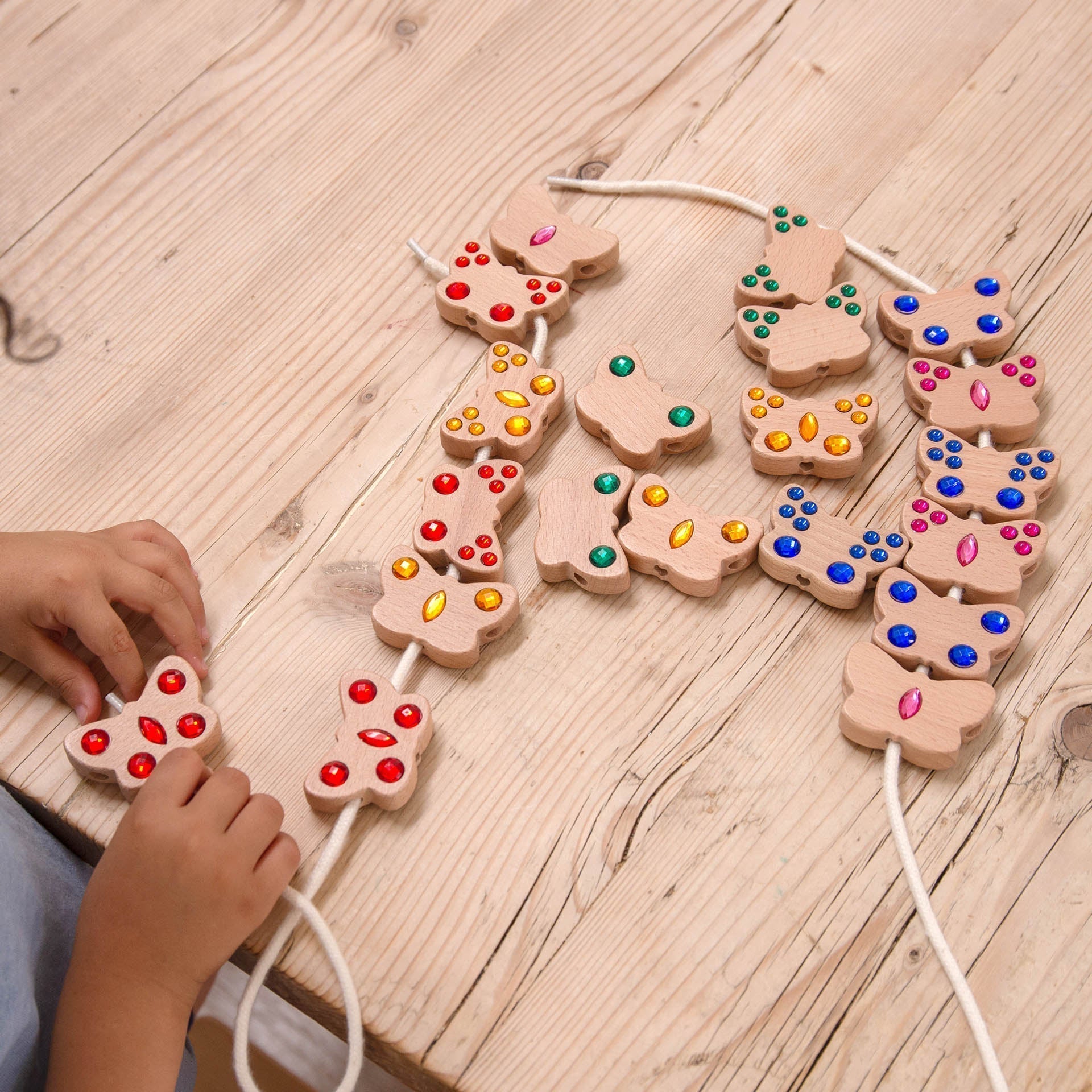Children's wooden letter blocks with colorful lights on a wooden surface