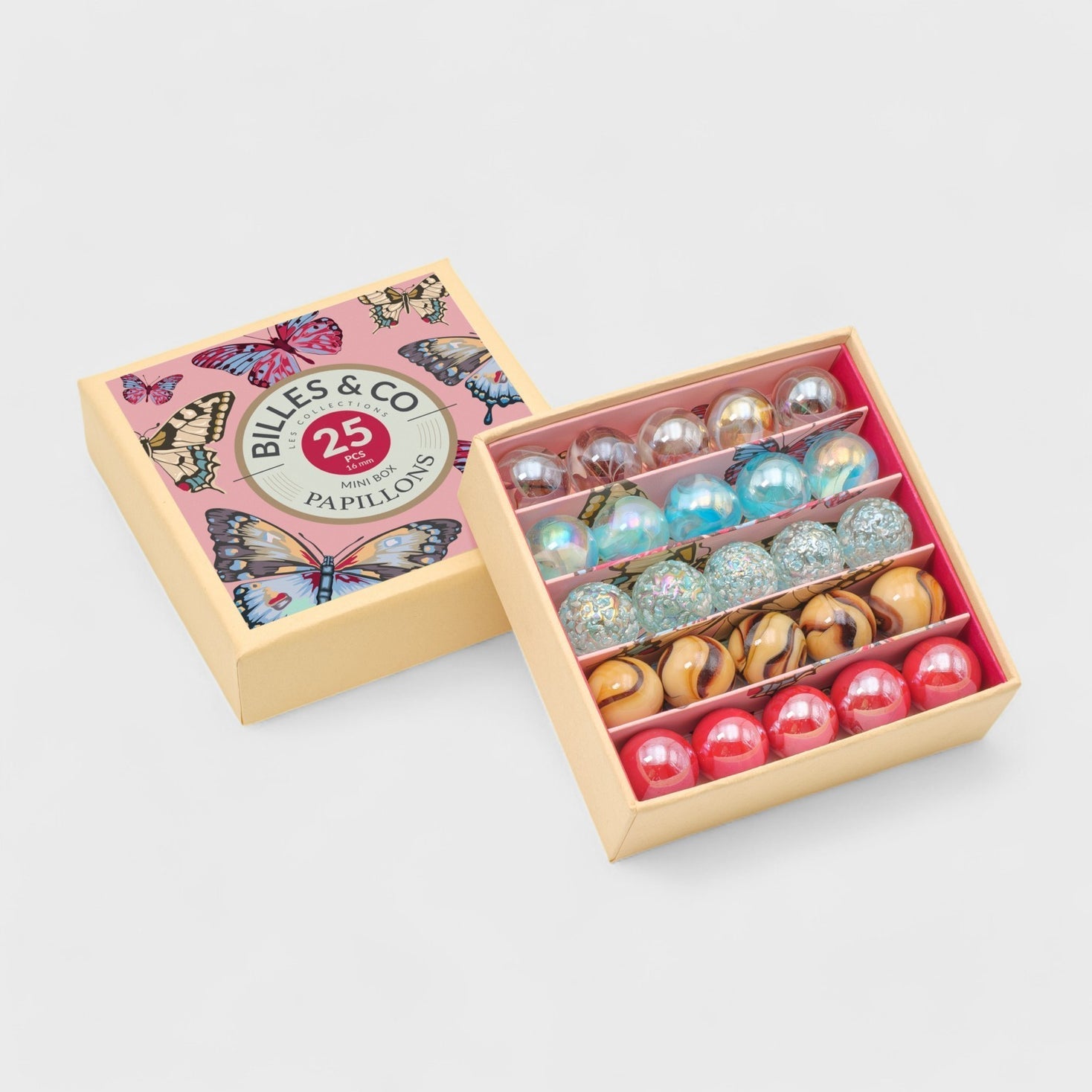 Box of colorful glass marbles with a decorative lid featuring butterflies and text.