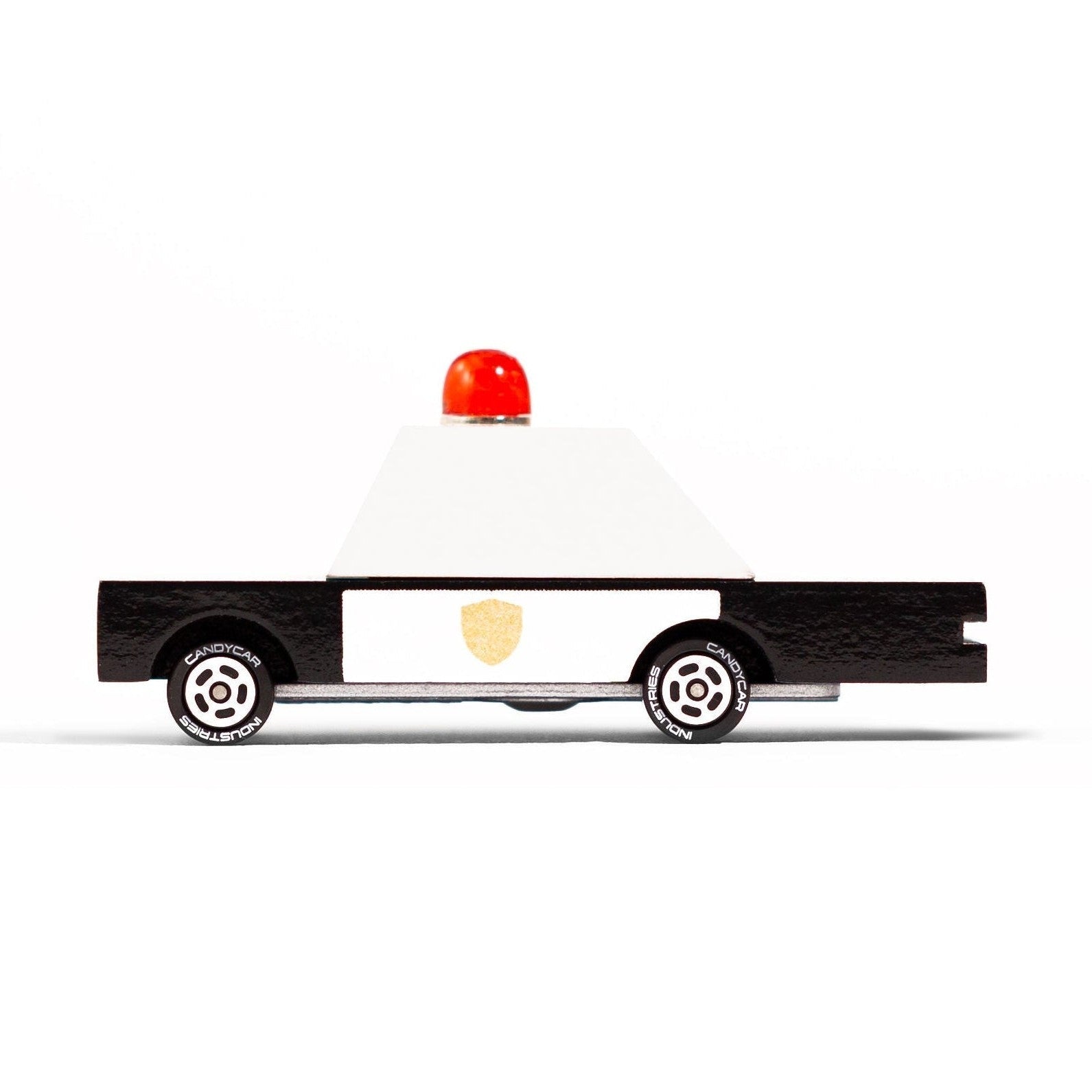 Toy police car with a red light on a white background