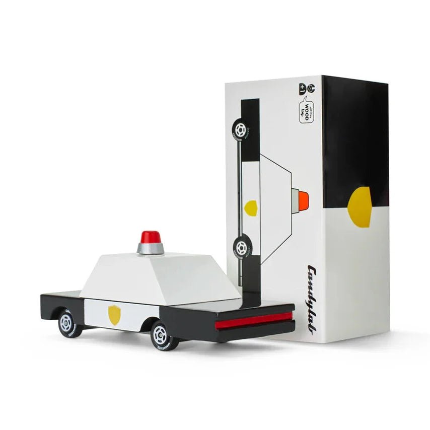Toy car with a red light and black and white box packaging on a white background
