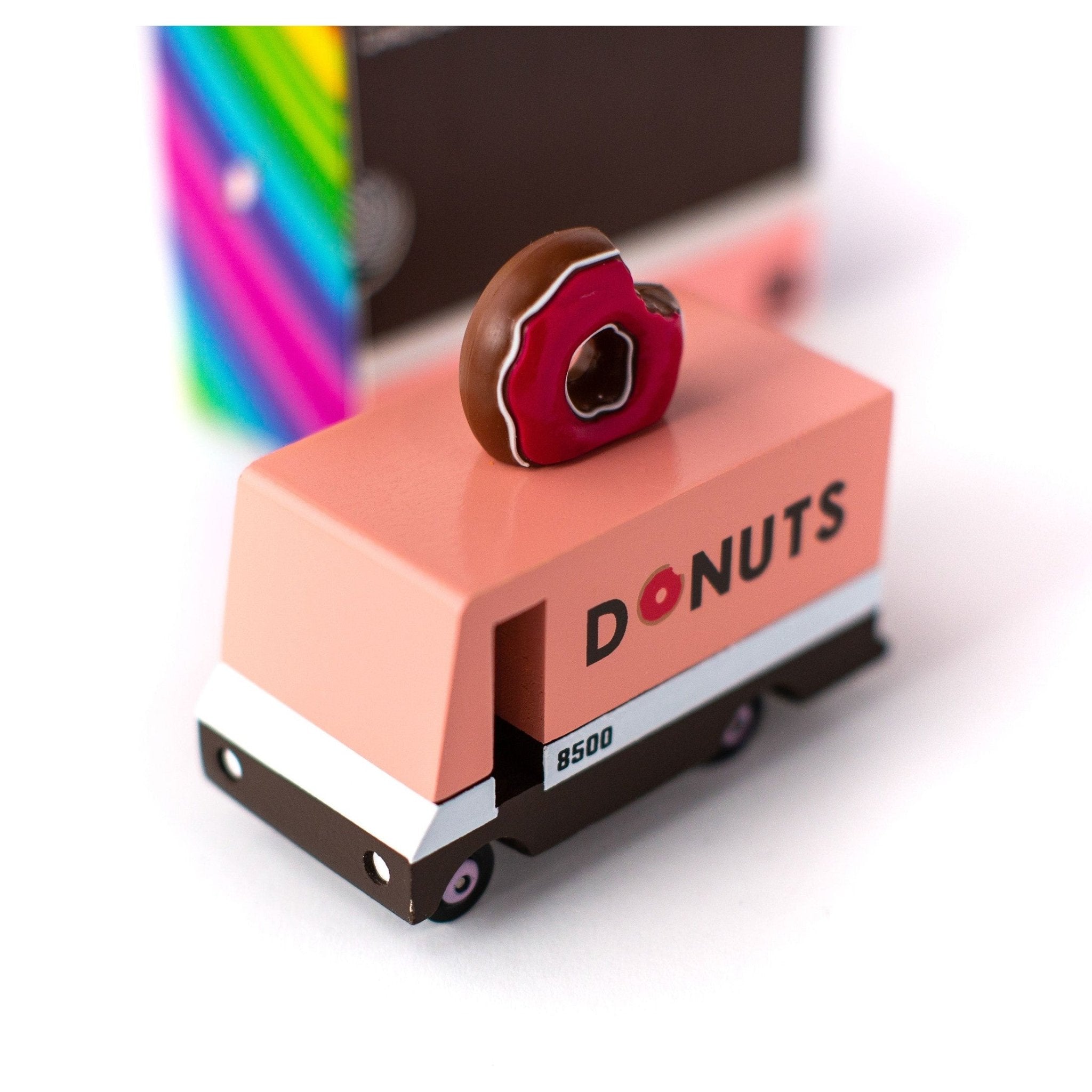 Donut-shaped object on a pink block with 'DONUTS' branding, colorful background