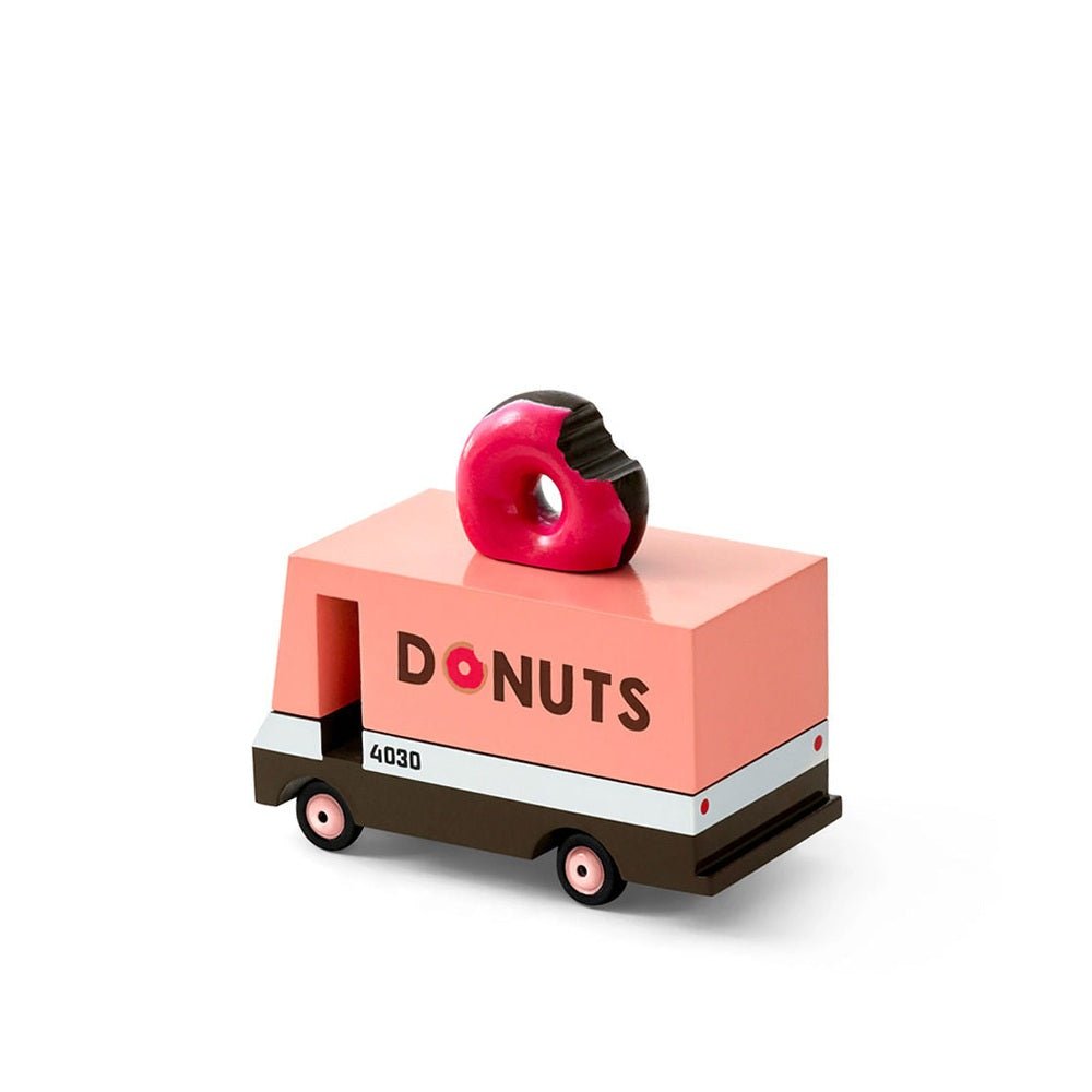 Toy donut truck with a pink donut on top against a white background