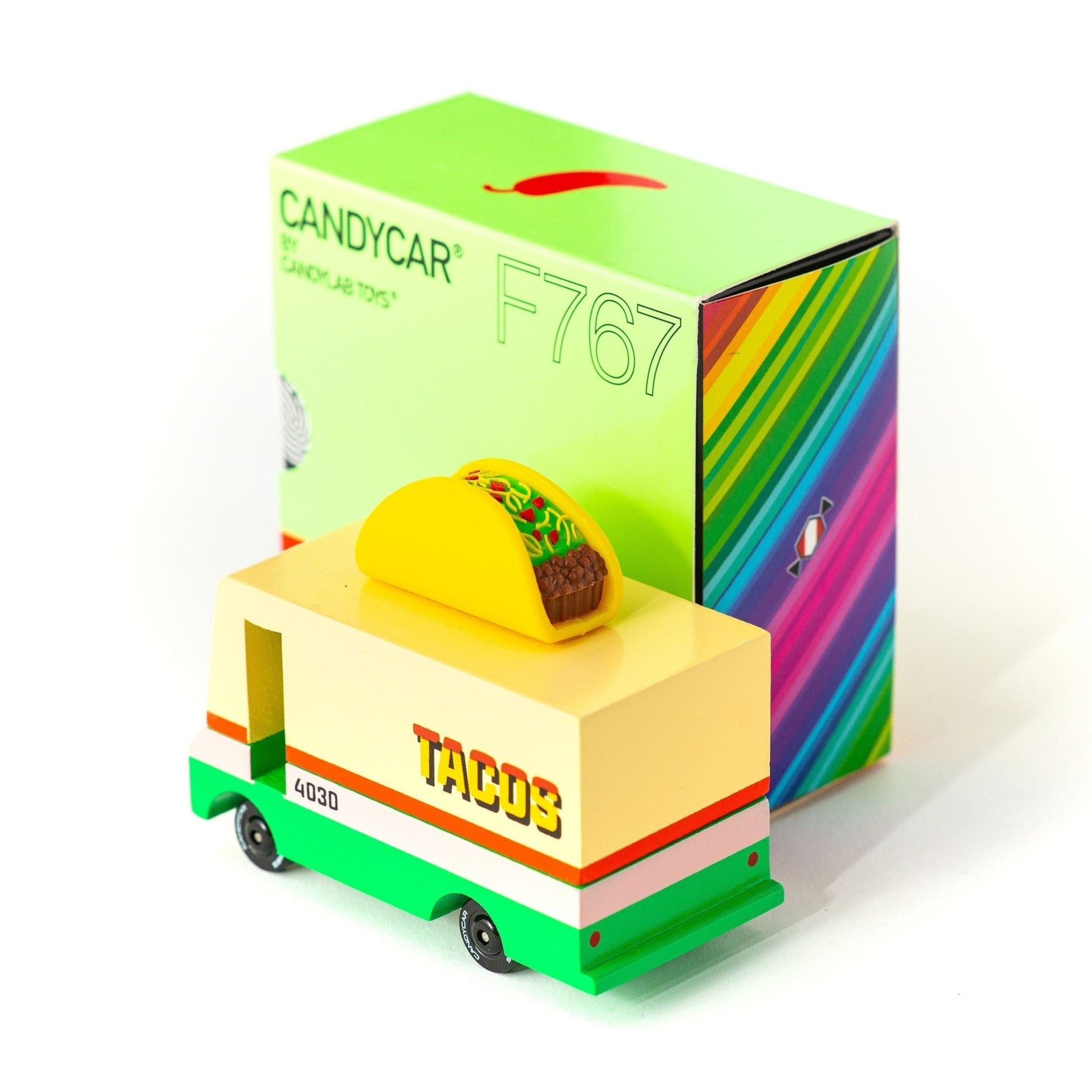 Toy truck with a taco on top and colorful box packaging on a white background