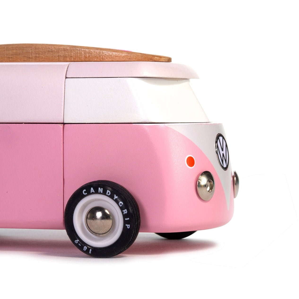 Pink Volkswagen camper van model on a white background