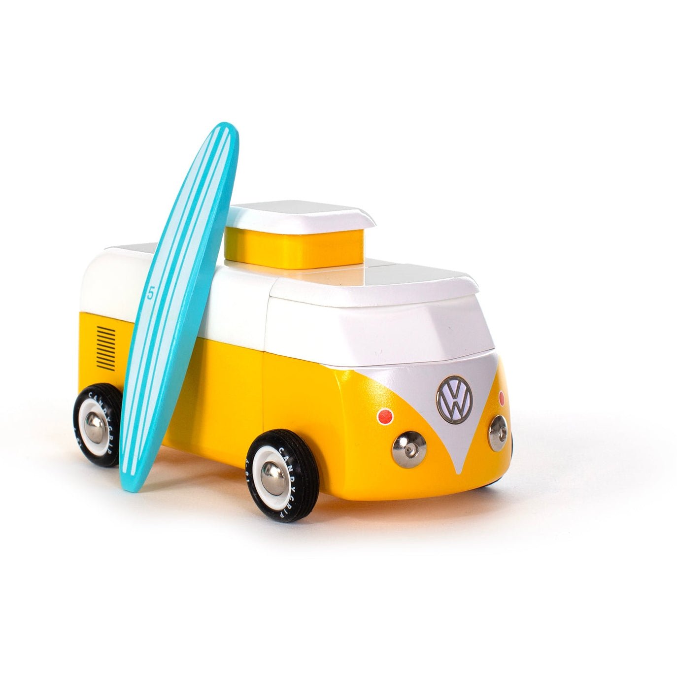 Toy Volkswagen camper van with a surfboard on a white background