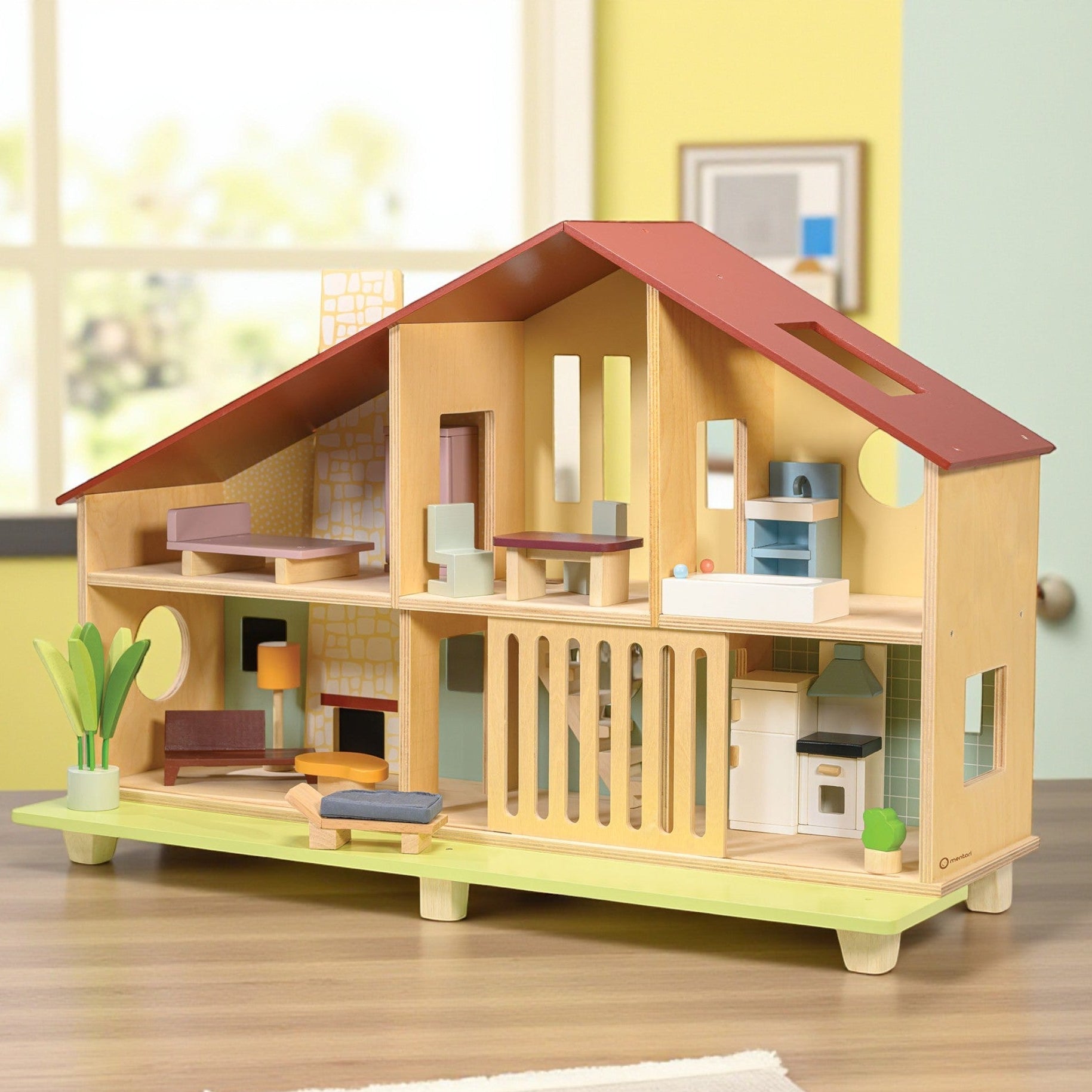 Wooden dollhouse with colorful furniture on a wooden floor.