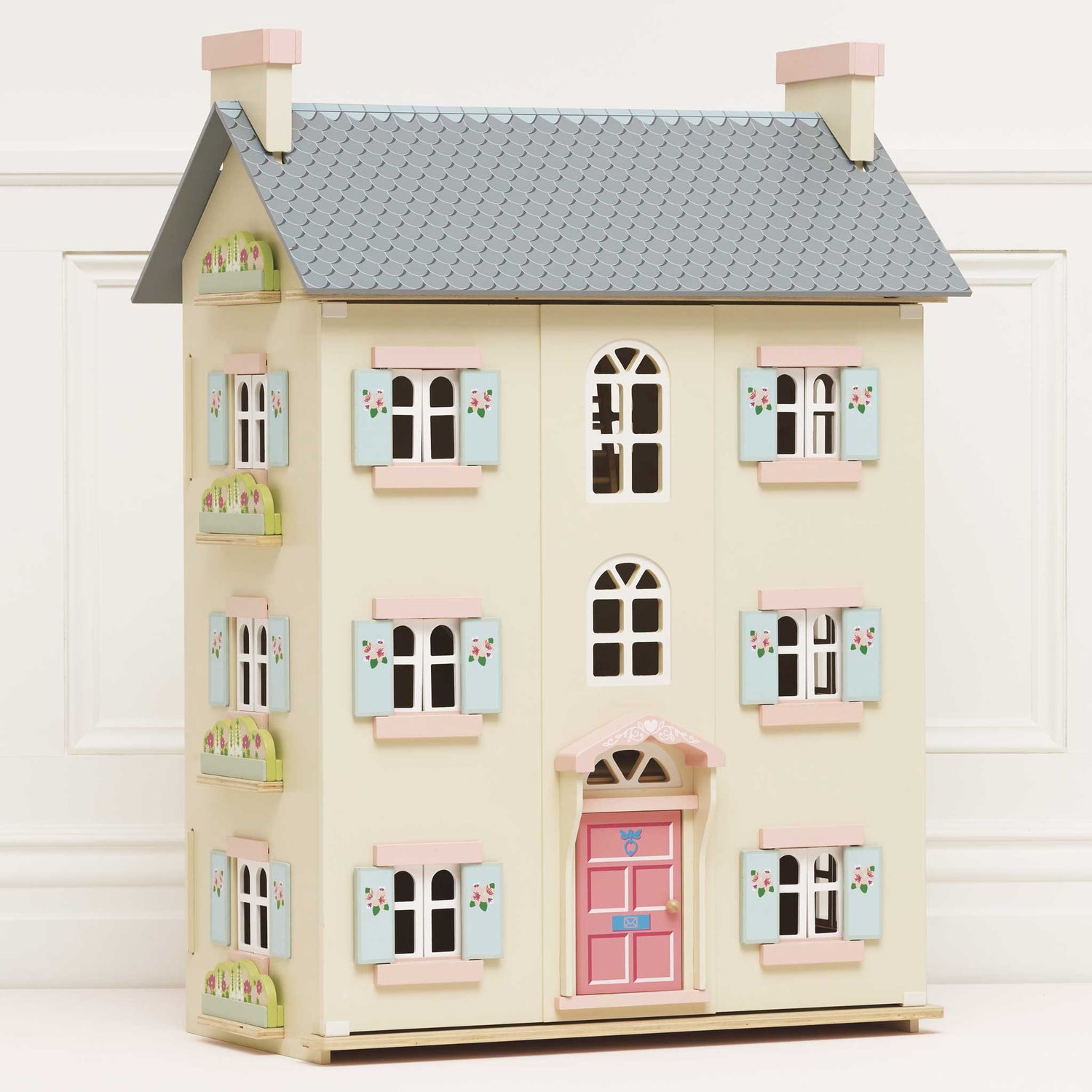 Toy dollhouse with pastel colors on a white background