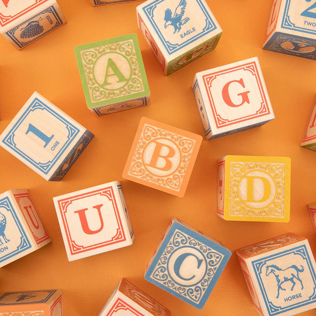 Colorful alphabet blocks on a textured surface