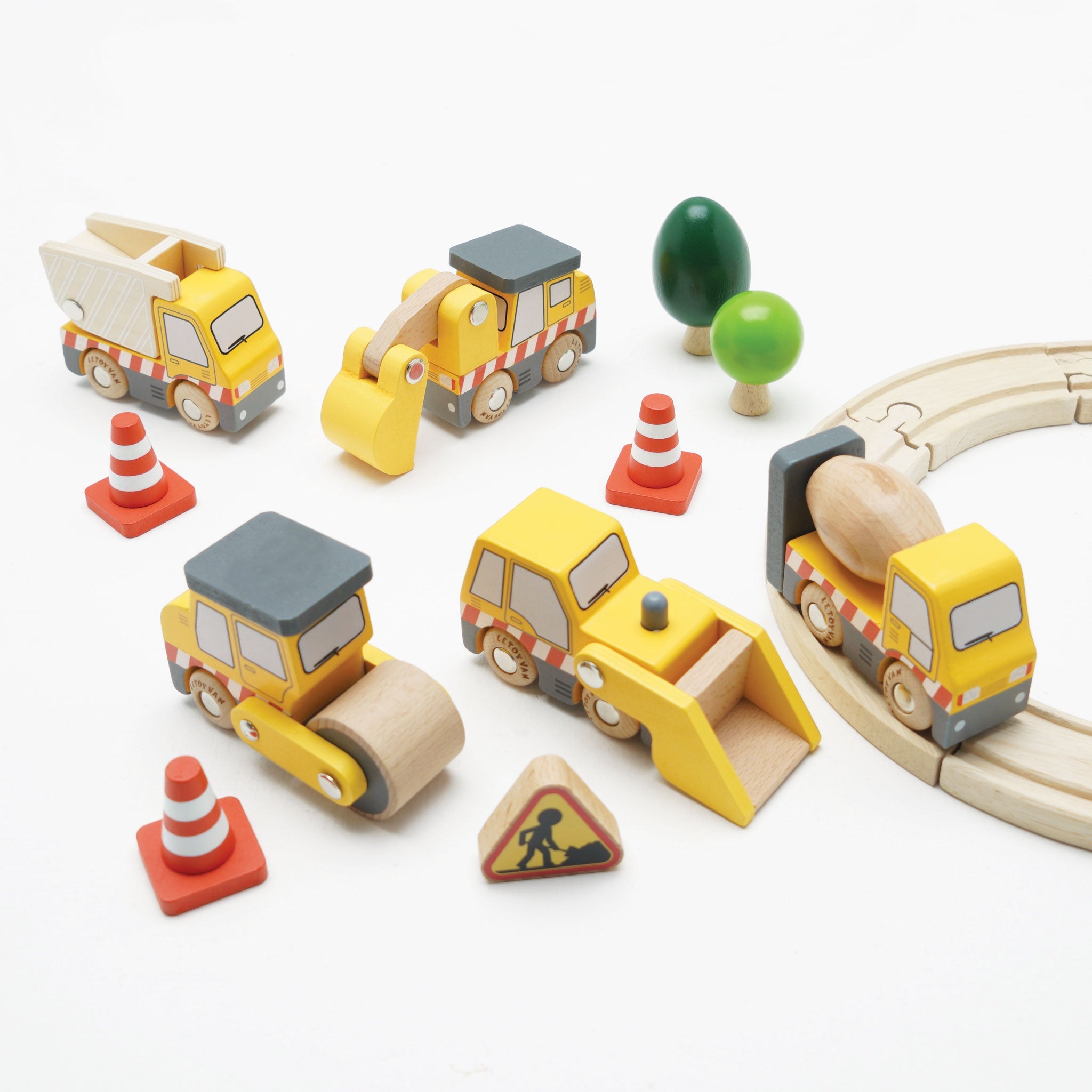 Set of wooden toy construction vehicles and traffic elements on a white background