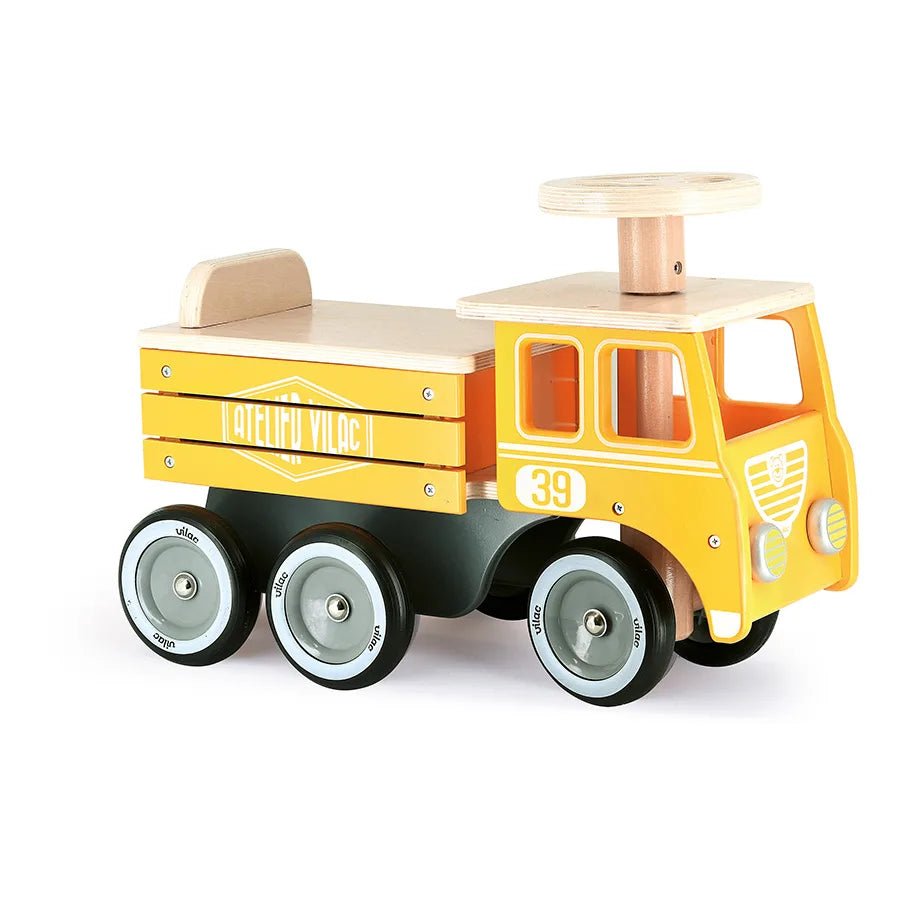 Yellow toy truck with wooden elements on a white background