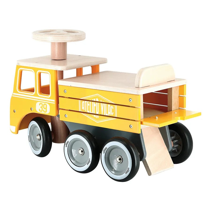 Wooden toy truck with yellow body and brown wheels on a white background