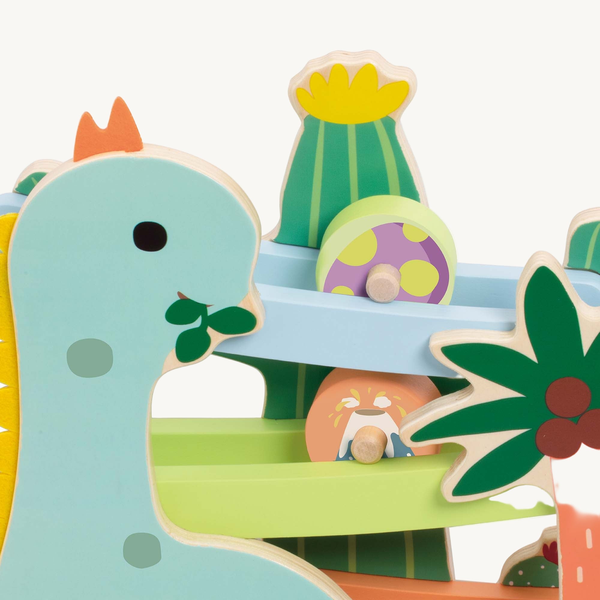 Colorful wooden toy with a dinosaur design and various small items on a white background
