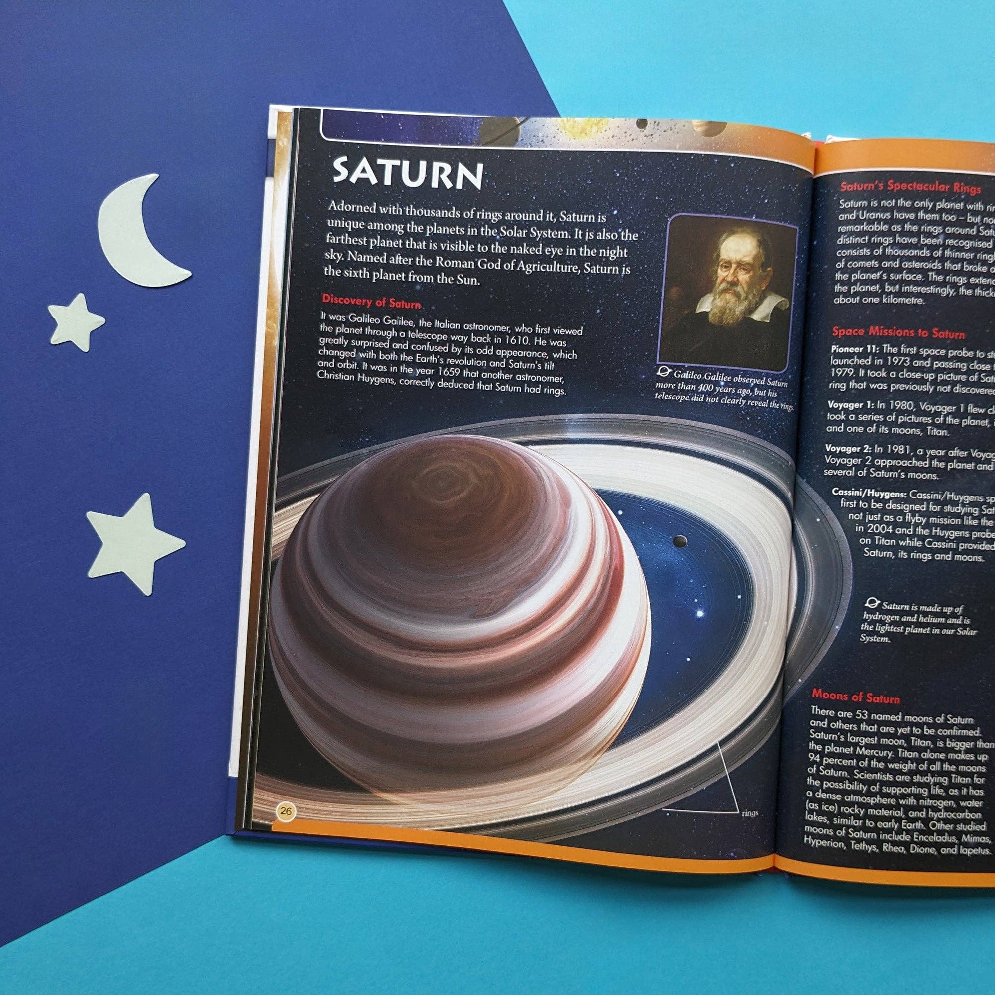 Open book about Saturn with a detailed illustration and text on a blue background