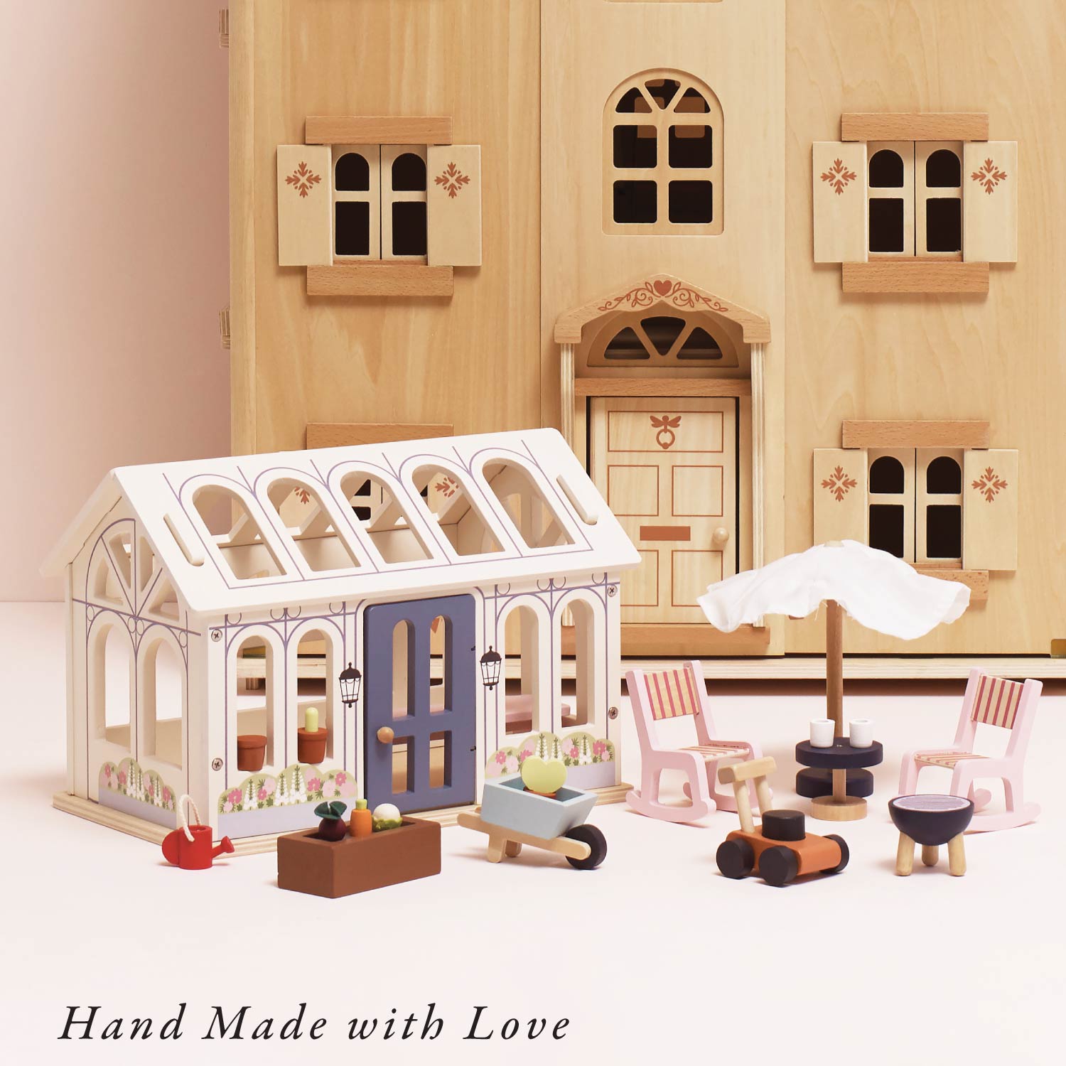 Wooden dollhouse with furniture and accessories on a light background