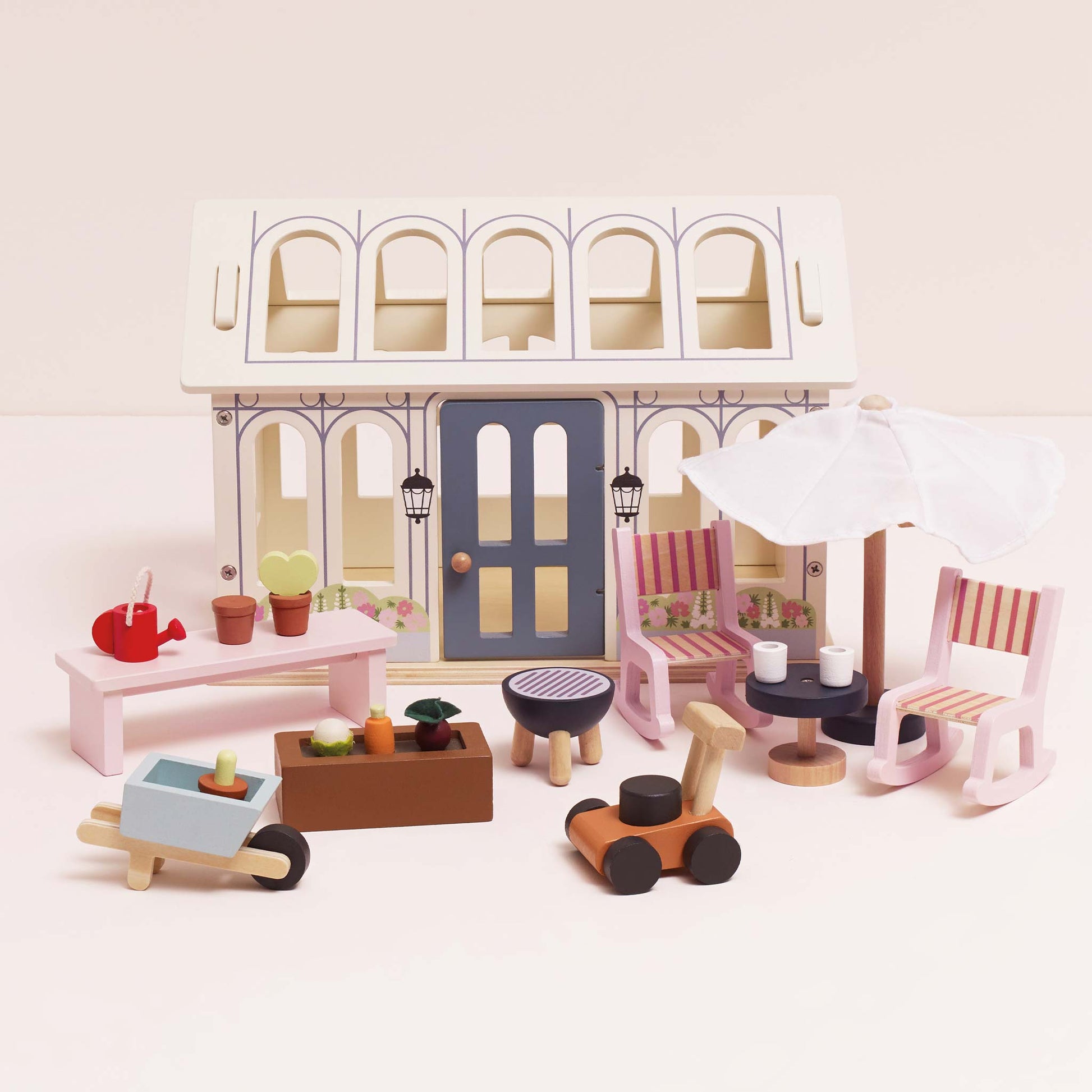 Set of wooden toys including furniture and accessories on a white background