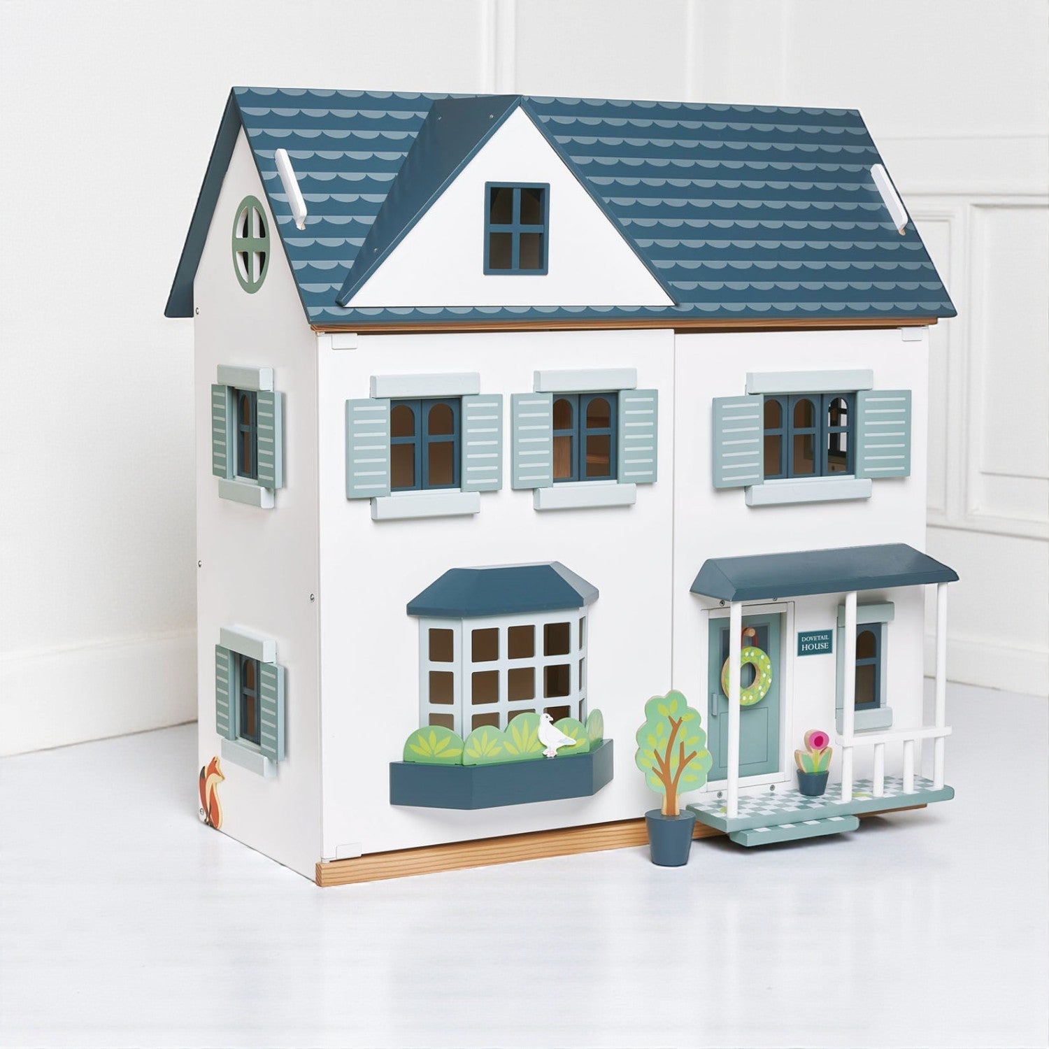 Toy dollhouse with blue and white details on a white background