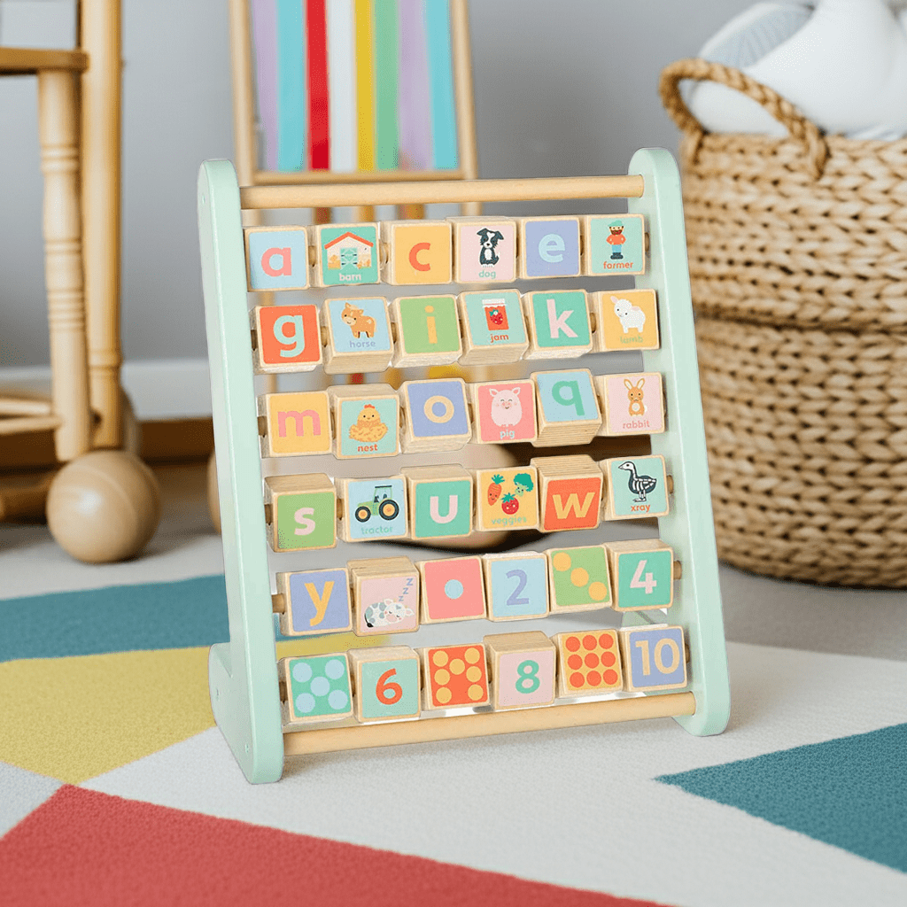 Children's wooden alphabet and number block set on a colorful rug