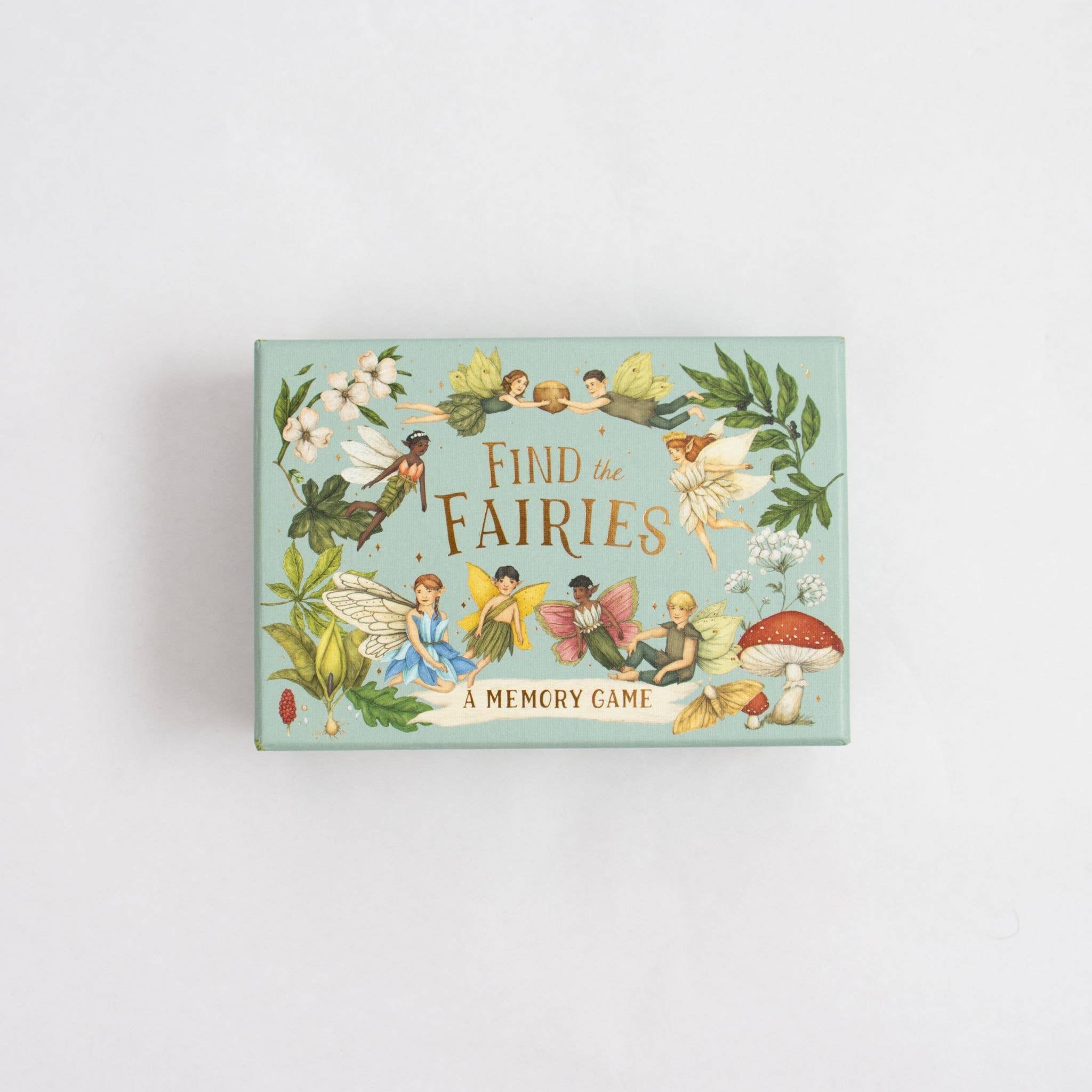 Memory game box with fairies and floral design on a light gray background