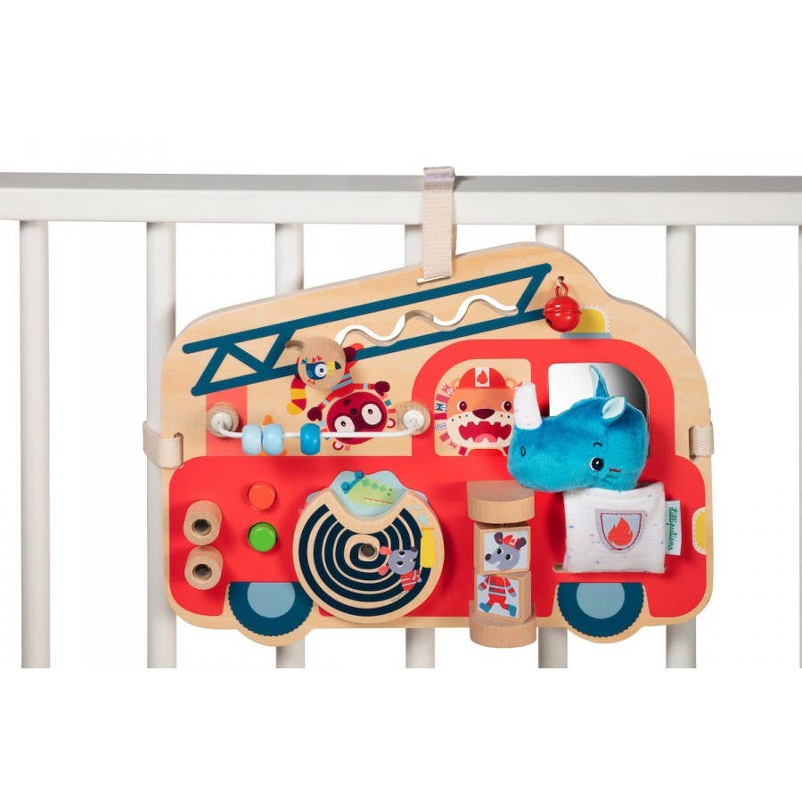 Children's fire truck toy with various interactive elements on a white background