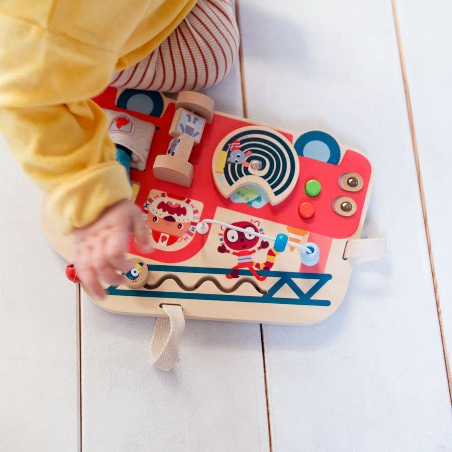 Child playing with a colorful wooden toy on a light wooden floor