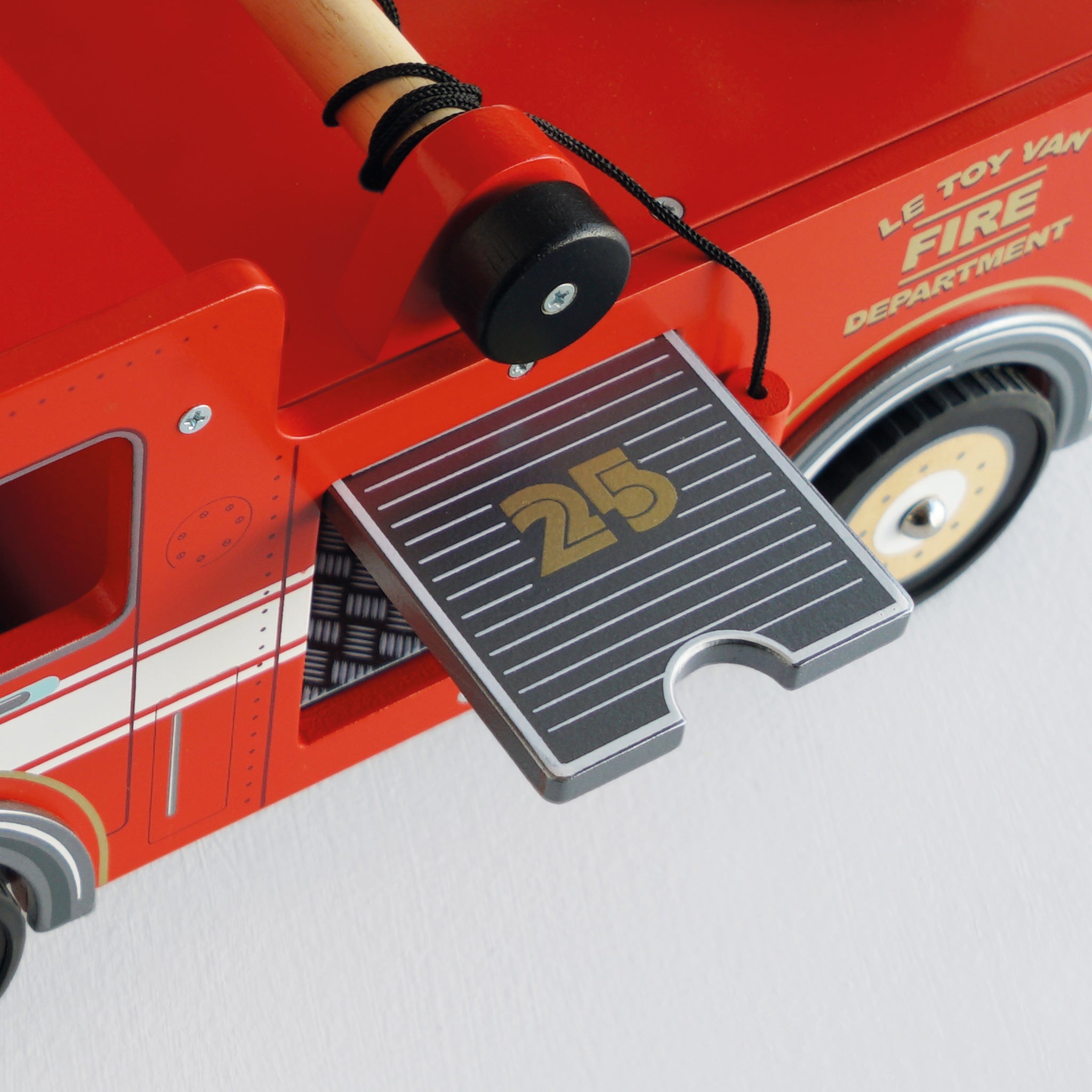 Red toy fire truck with a step platform labeled '25' on a light gray background