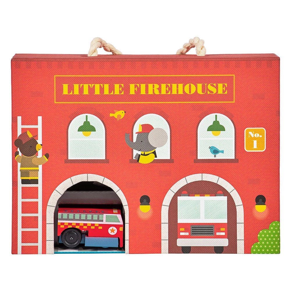 Red toy firehouse with fire trucks and animal figures on a white background