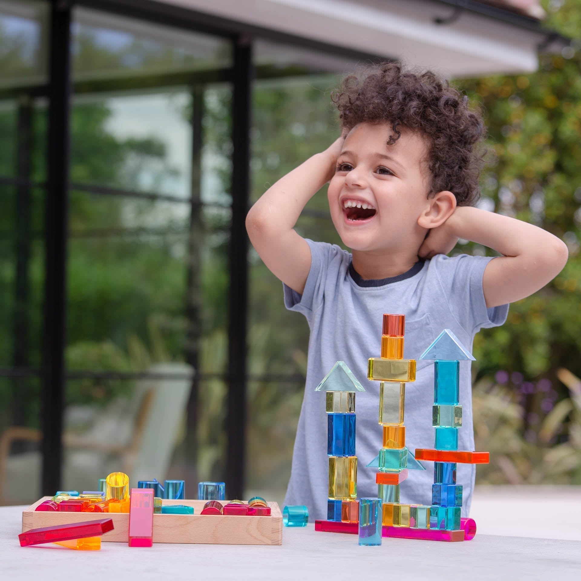 Child playing with colorful building blocks outdoors