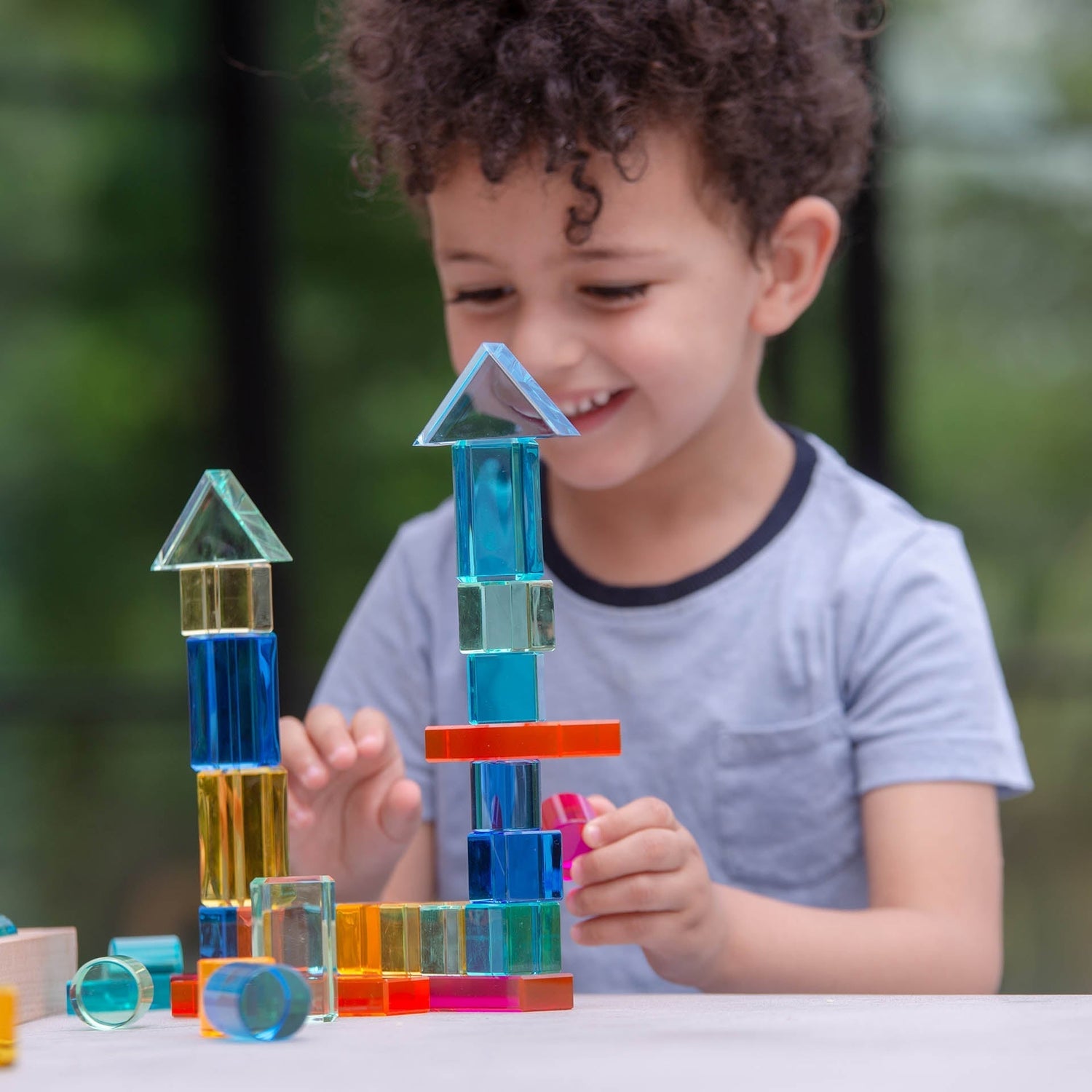 Child playing with colorful building blocks outdoors