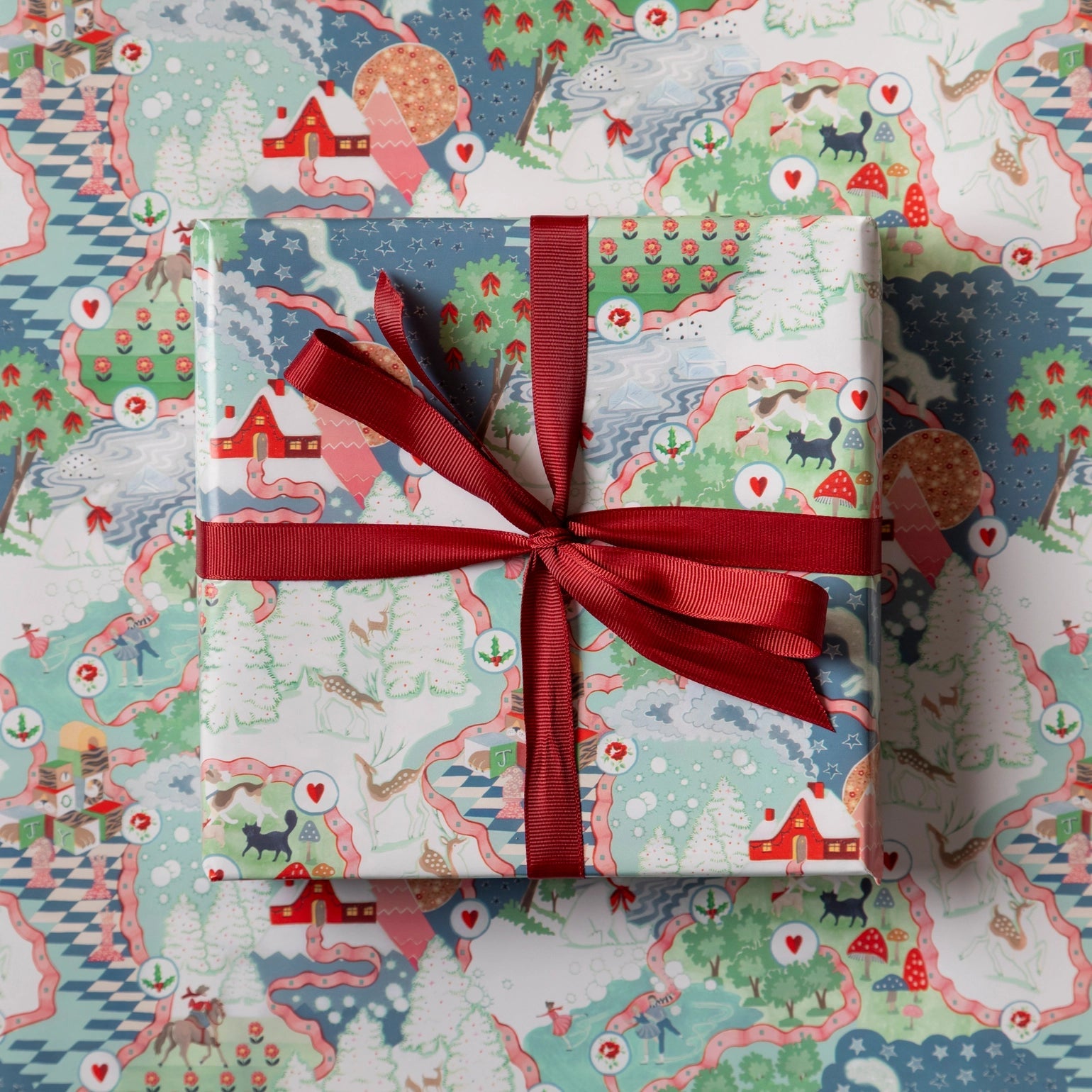 Gift box with red ribbon on a patterned background