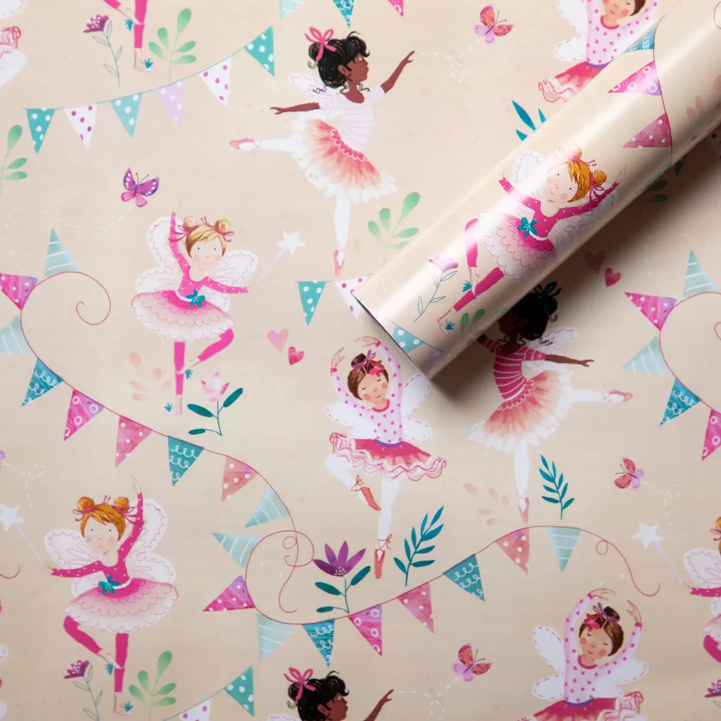 Roll of decorative paper with fairy designs on a beige background