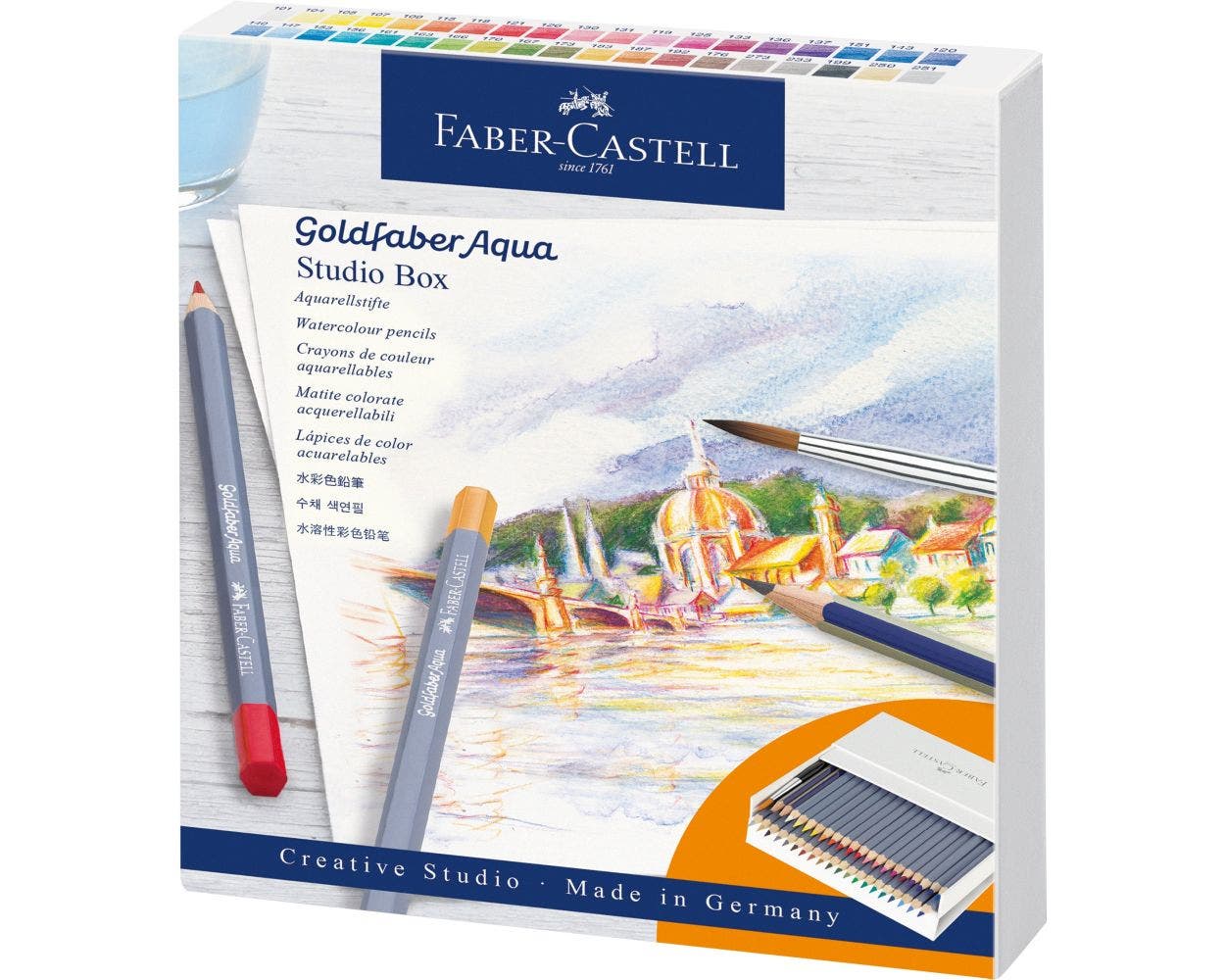 Faber-Castell Goldfaber Aqua Studio Box packaging with watercolor pencils and a brush on a scenic background.