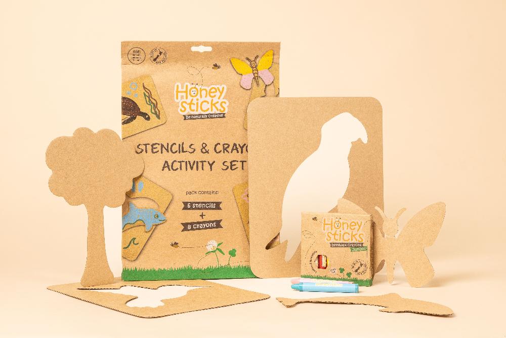 Honey Sticks stencils and crayons activity set on a beige background