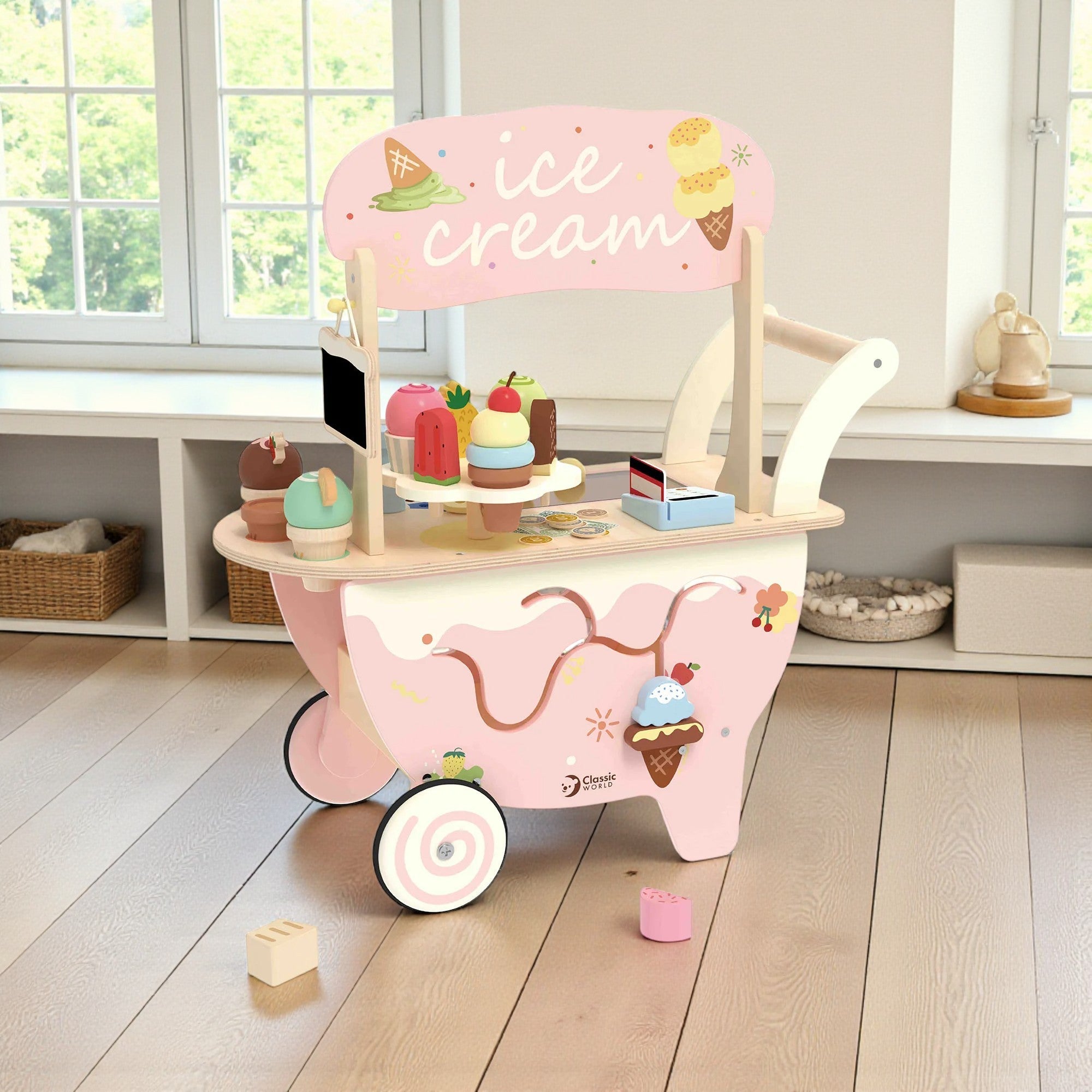 Pink toy ice cream cart with wooden shelves and ice cream-themed decorations on a wooden floor.