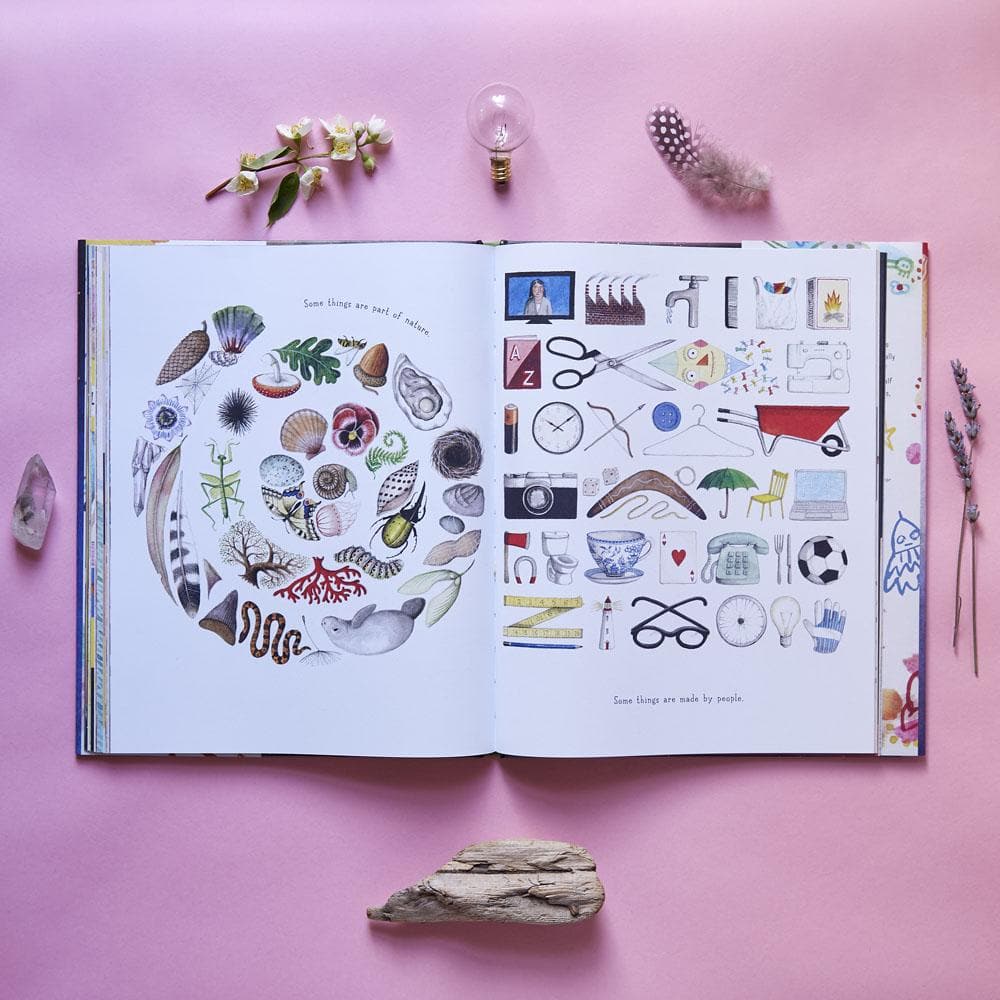 Open book with illustrations on a pink background